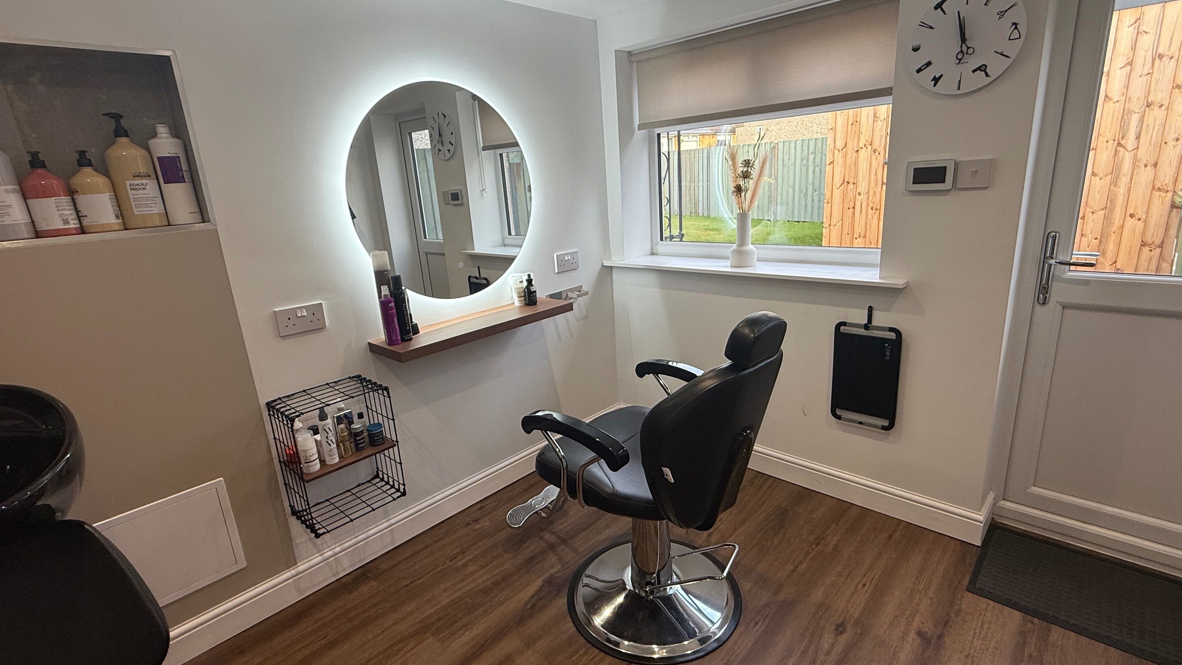 Elegant styling chair and mirror setup at Hair by Stassia in Lenzie, Scotland, GB.