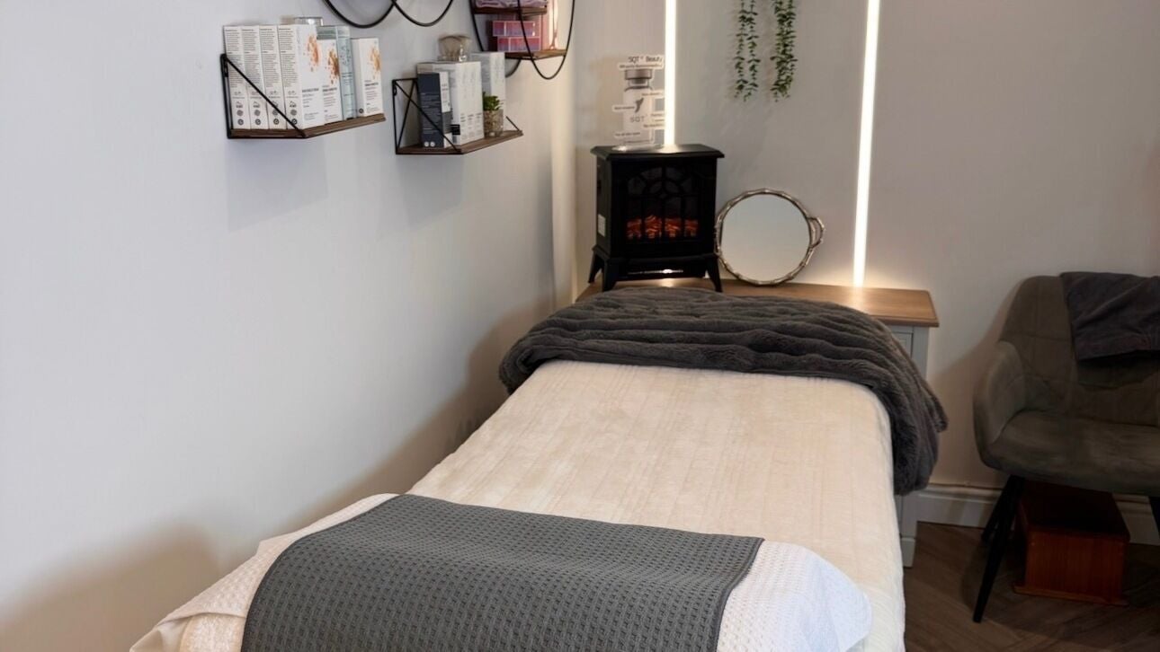 Cozy treatment room at NUYU Skin Clinic, Erith, England, GB, with a massage bed and elegant decor.
