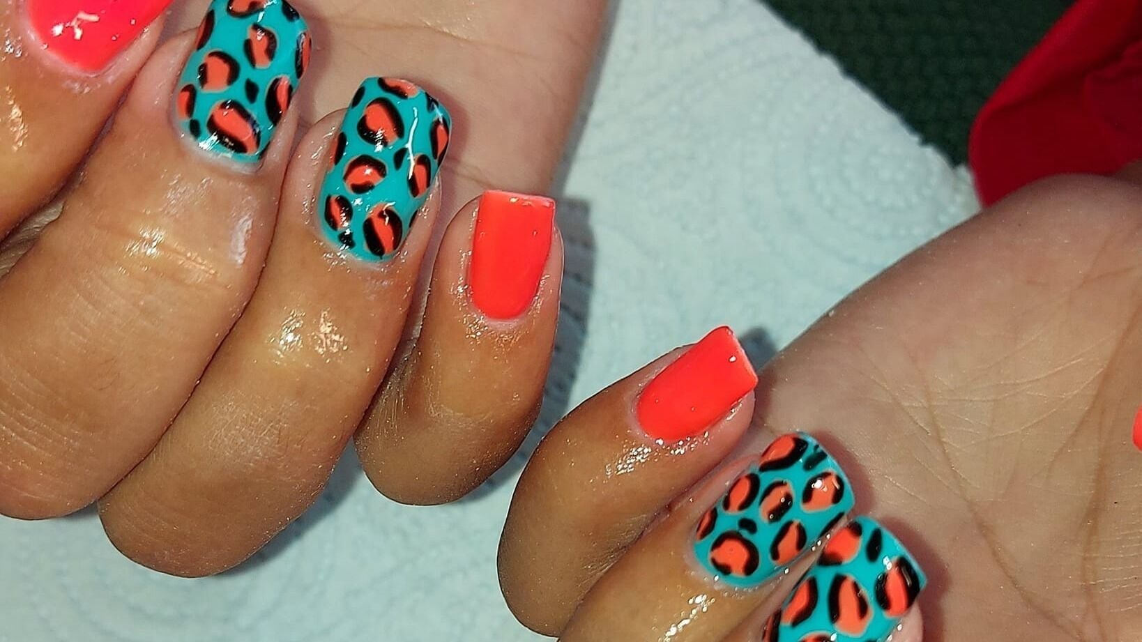 Vibrant tropical nail art at SVJ Beauty, Whitehaven, England, GB showcasing bright colors and bold patterns.