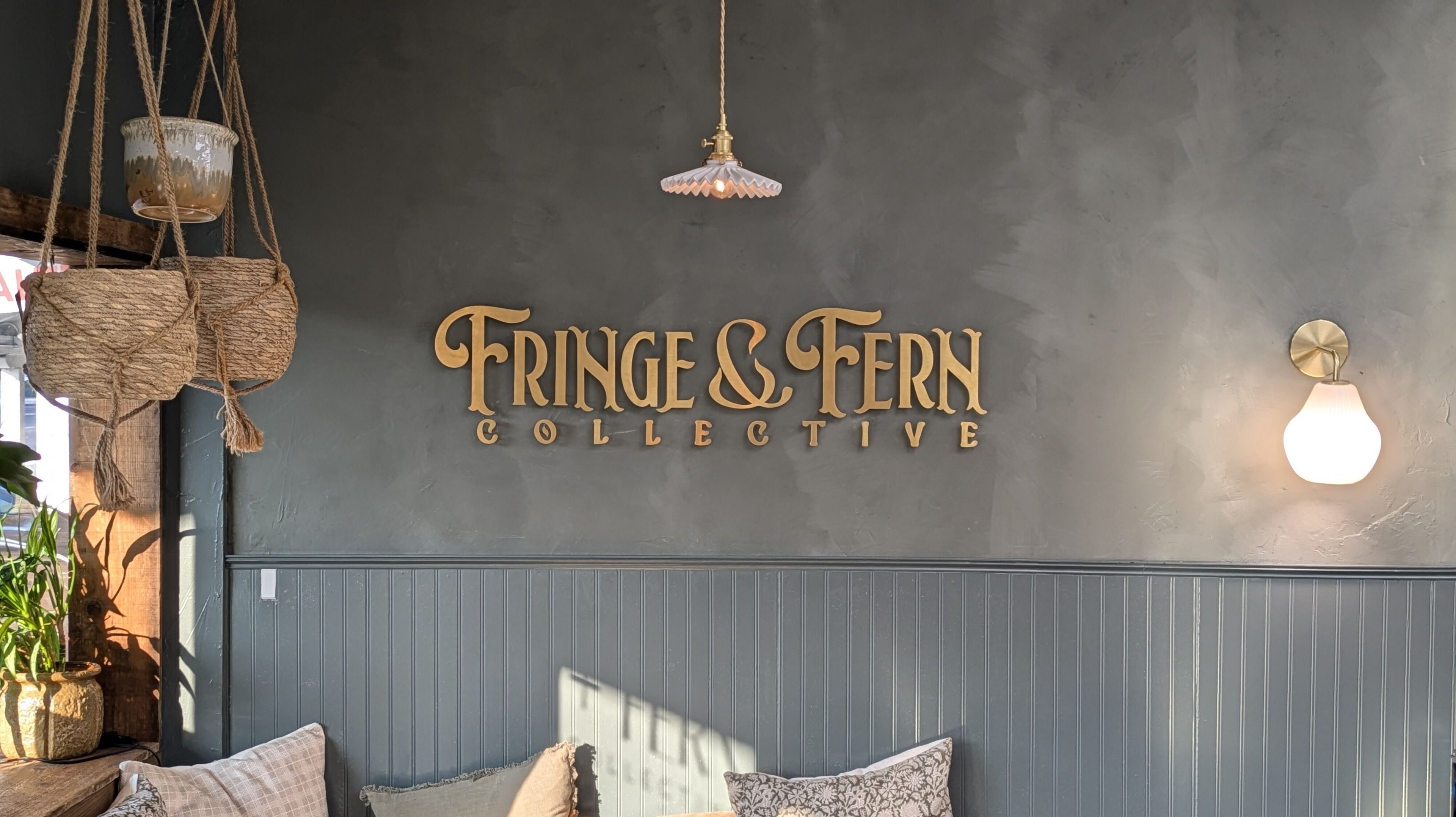 Fringe & Fern Collective's cozy lounge area with hanging plants, Walnut Creek, California, US.