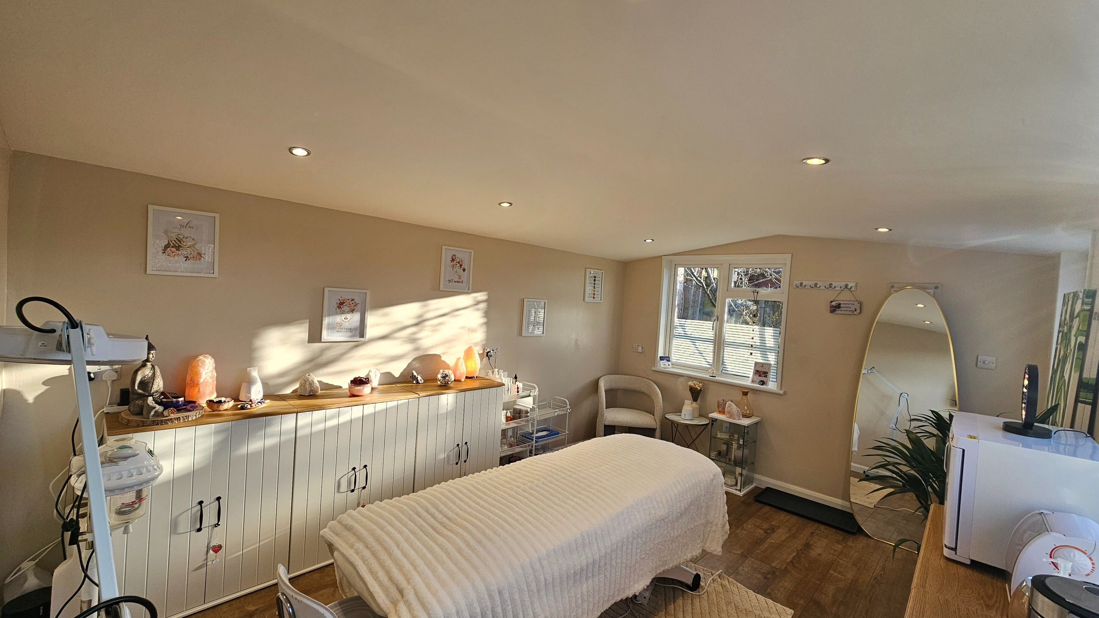 Relaxing treatment room at Nadia's Beauty Room, Rochester, England, GB with warm decor and ambient lighting.