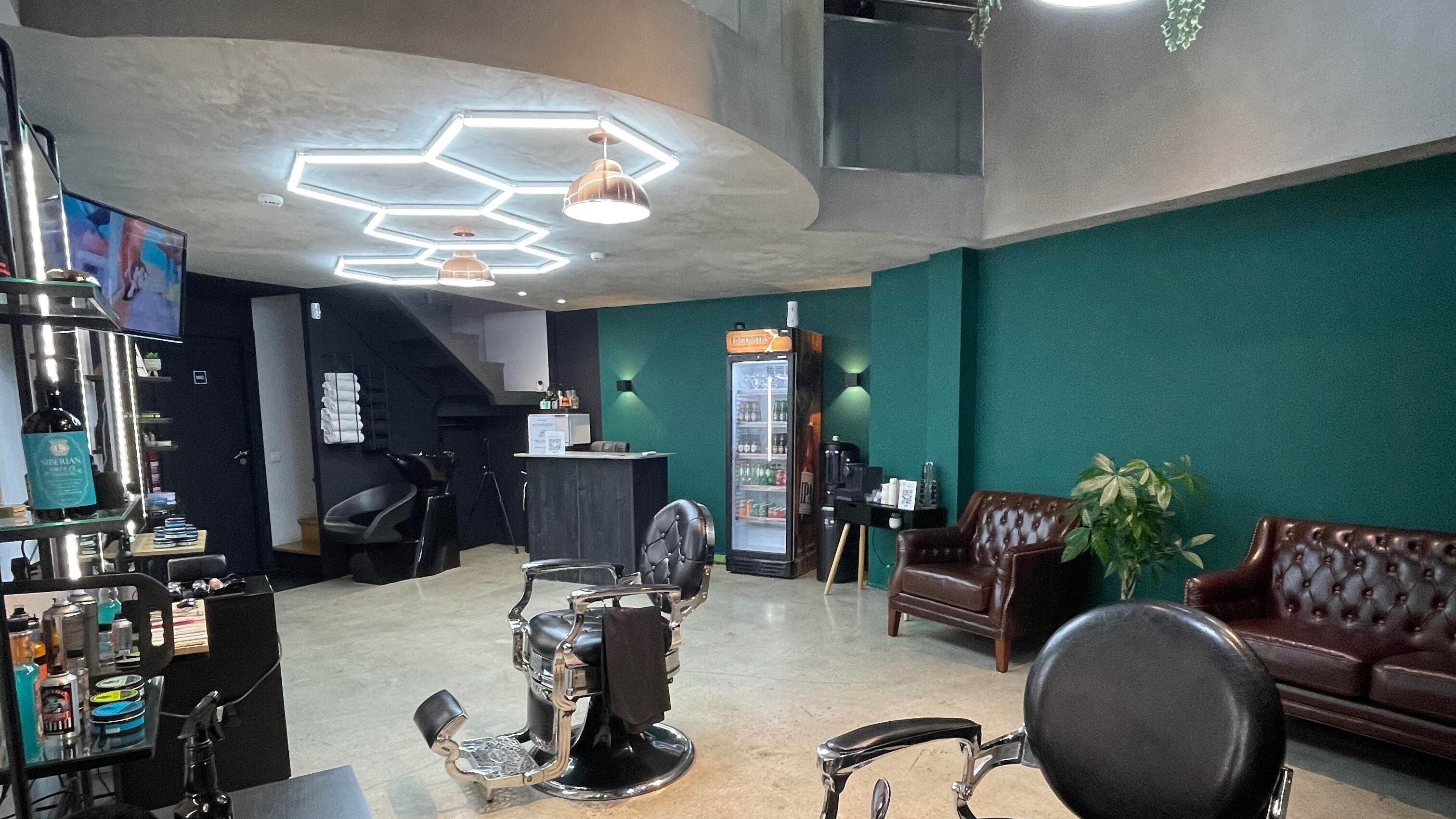 Interior of Augustus Barbershop in Lisboa, Lisboa, PT with modern chairs and retro decor.