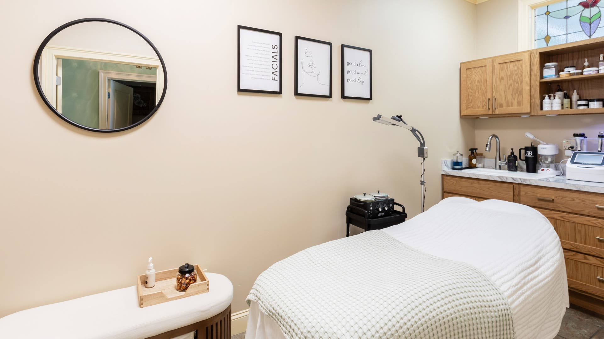 Cozy treatment room at Bare Beauty Aesthetics, Ludlow, Massachusetts, US, featuring a massage bed and warm decor.