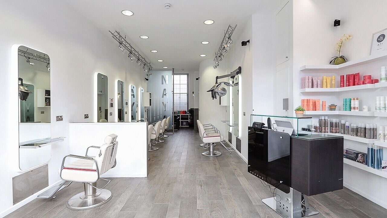 Chic interior of Naya Hair & Beauty in London, England, GB featuring sleek styling stations and bright decor.