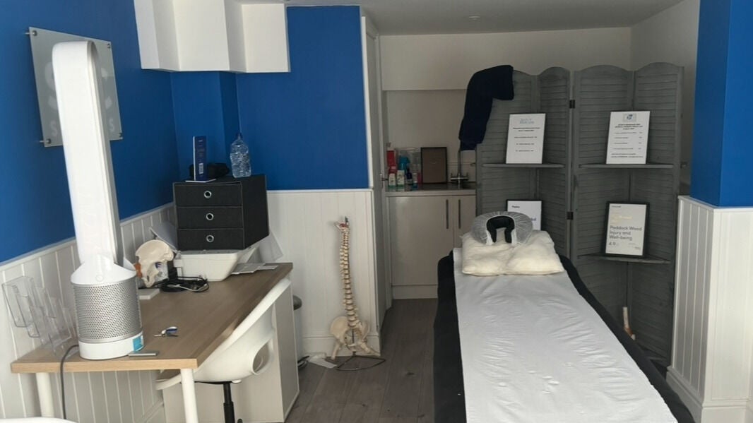 Therapy room at SPC Sports Therapy, Paddock Wood, England, GB. Features massage table, spine model, and blue walls.