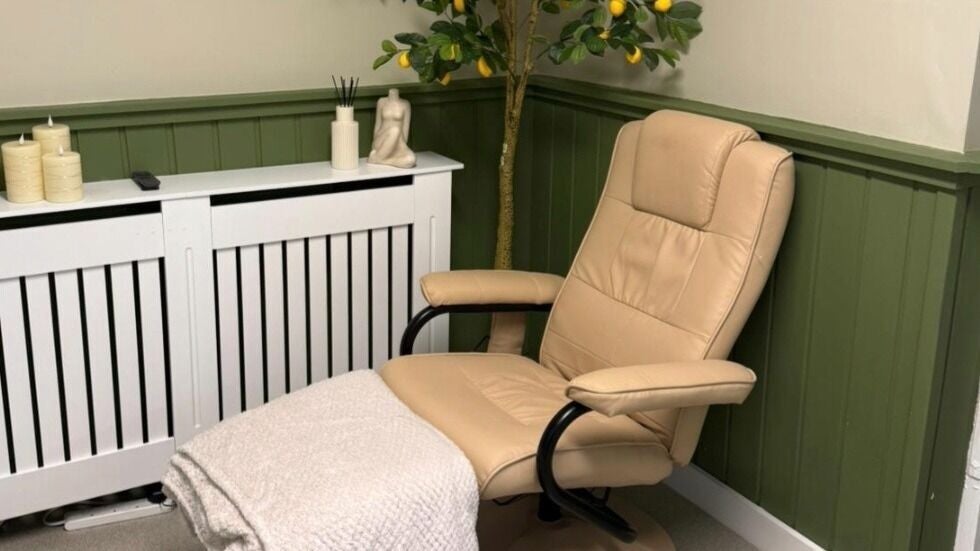 Comfortable beige chair with a cozy blanket at Lm Hair And Beauty Lounge, Sheffield, England, GB.