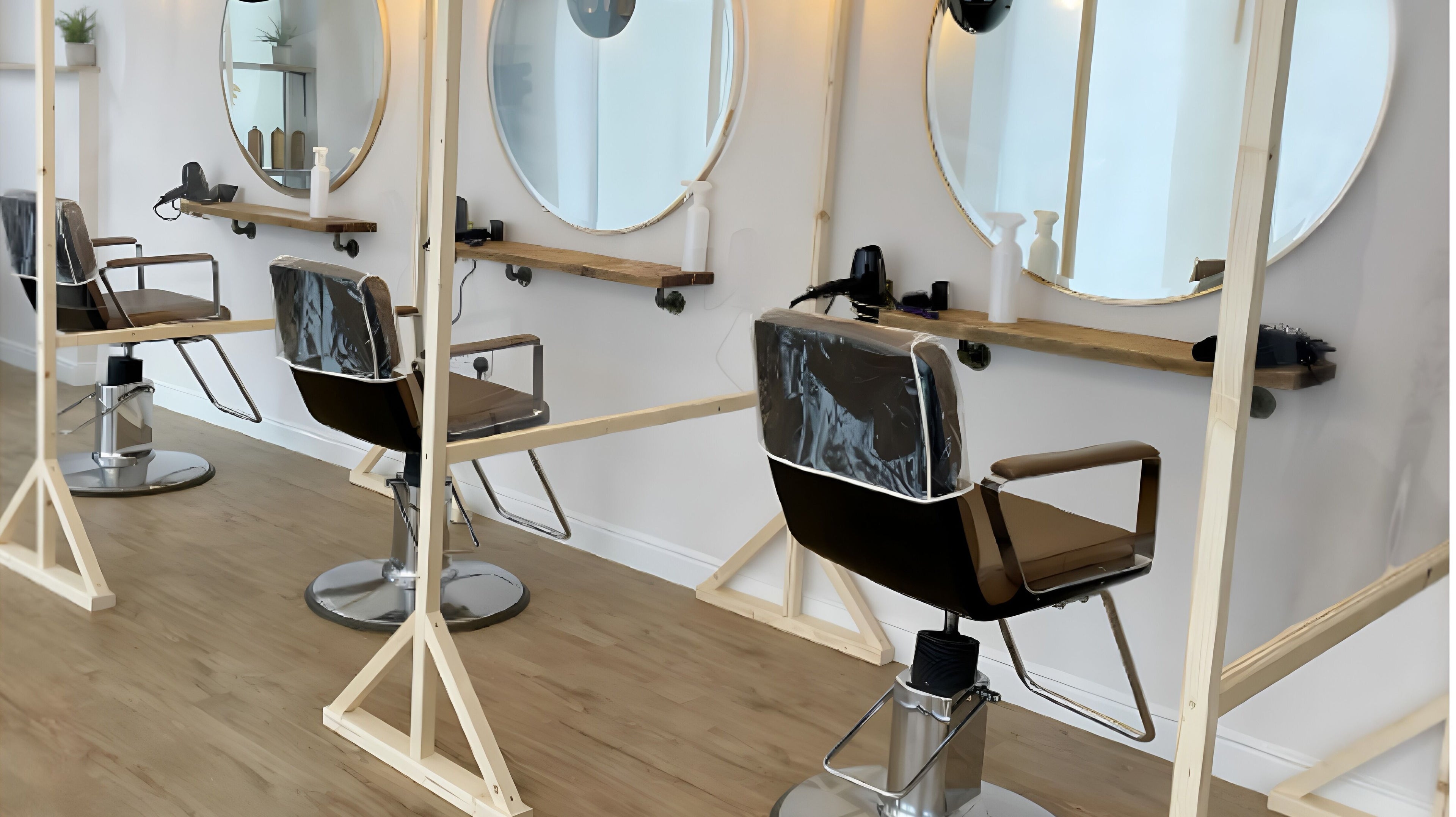 Stylish salon chairs with round mirrors at One Seven Four, Tonbridge, England, GB offering a modern aesthetic.