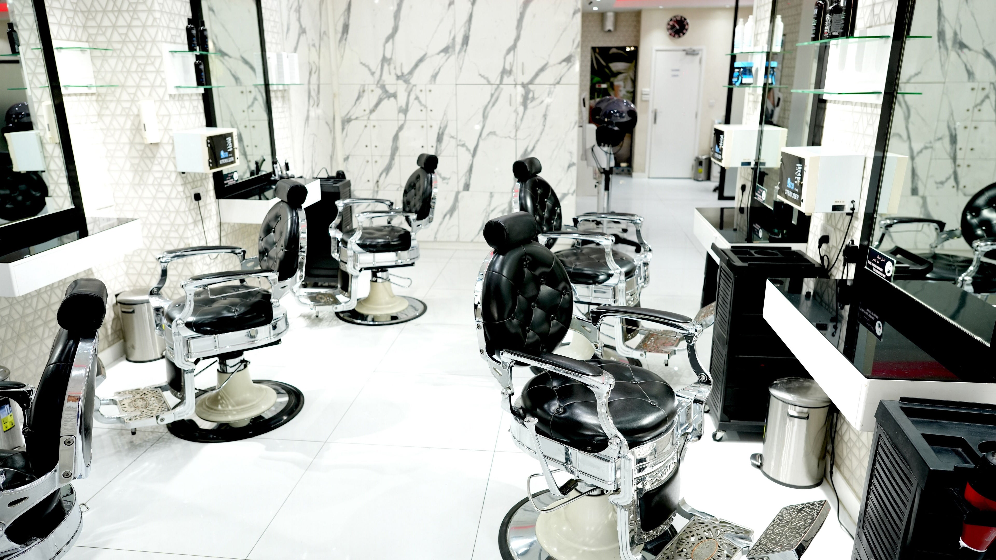 Modern interior of Quality Fix Gents Salon at Mai Tower, Dubai, AE, featuring stylish barber chairs.