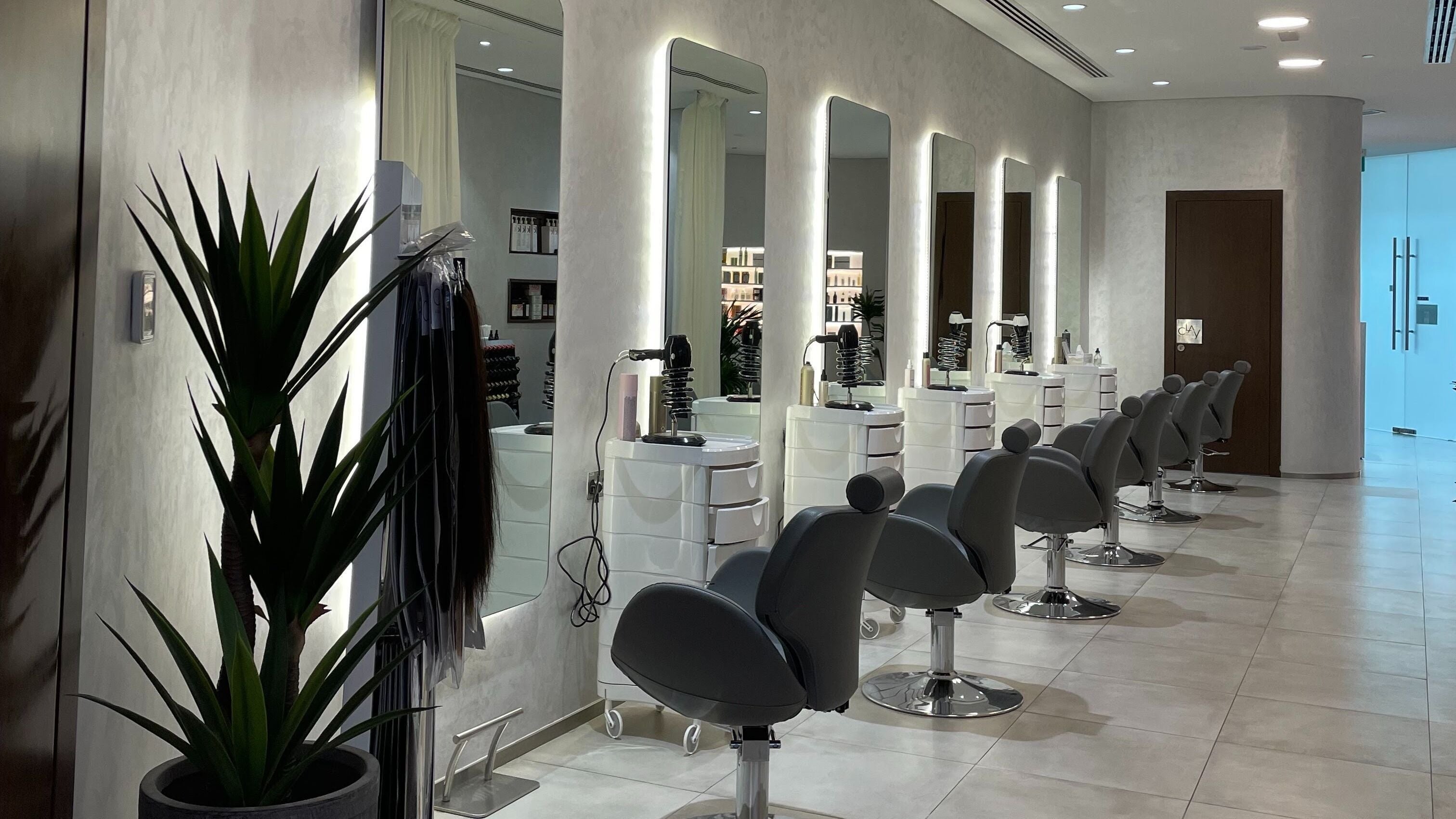 Modern salon interior at Clay Beauty Lounge - Khaldiya, Abu Dhabi, AE, showcasing elegant styling stations.