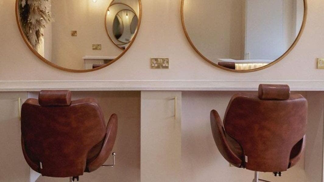 Luxurious salon chairs and mirrors at LUX in Glasgow, Scotland, GB, offering refined beauty experiences.