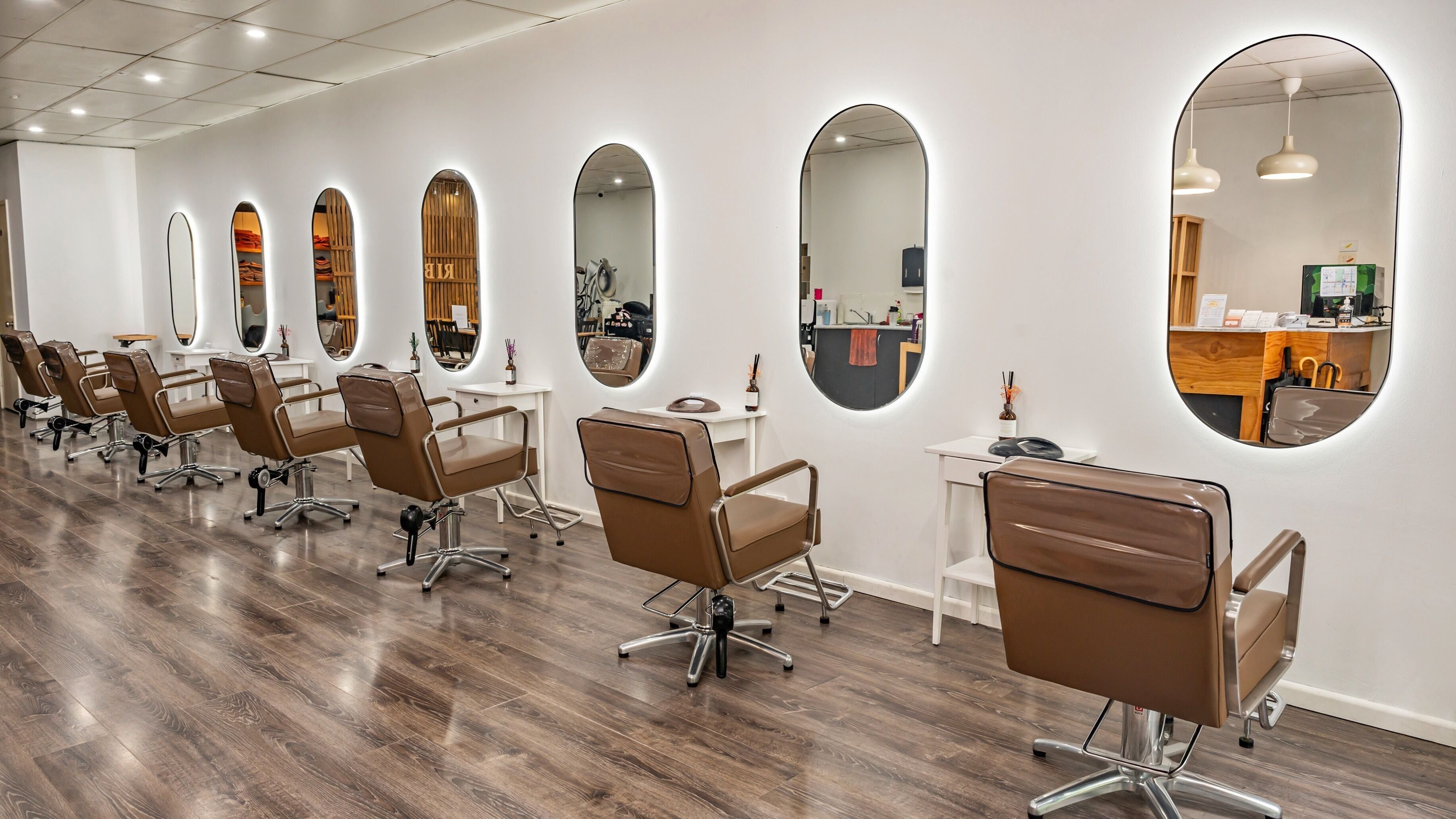 Sleek salon chairs and mirrors at Ribbon Hair - 456 La Trobe St West Melbourne, Melbourne, Victoria, AU.