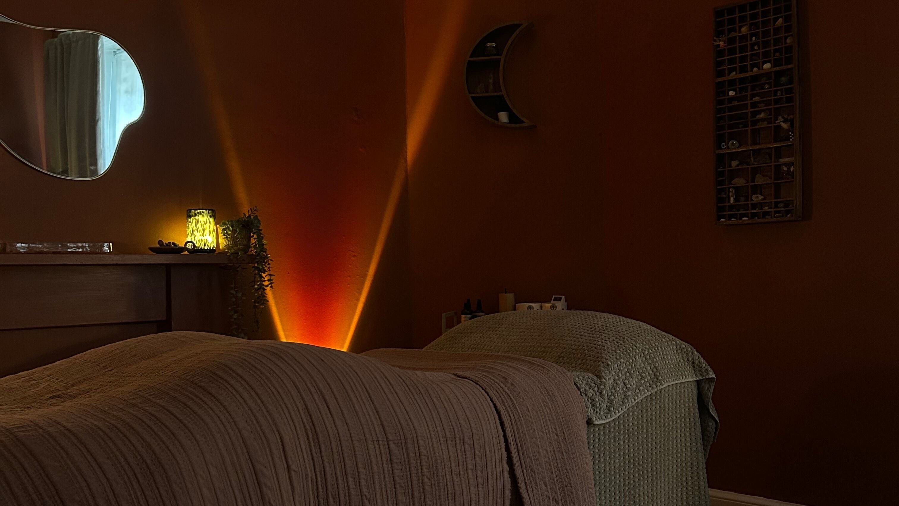 Cozy massage room at Unwind, Glasgow, Scotland, GB with soft lighting and earthy tones.