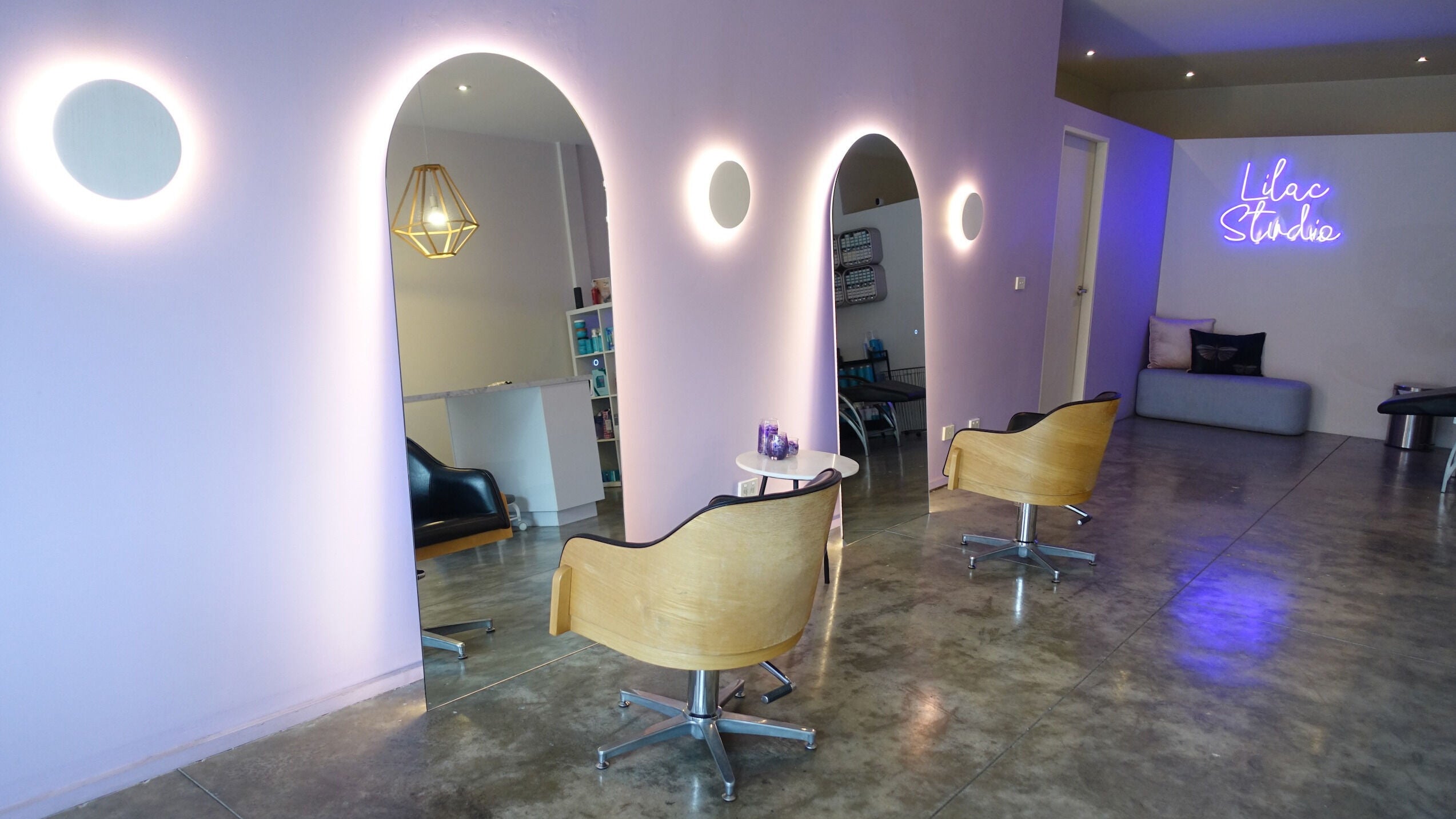 Chic interior of Lilac Studio Hair, Brunswick East, Victoria, AU with modern seating and stylish mirrors.