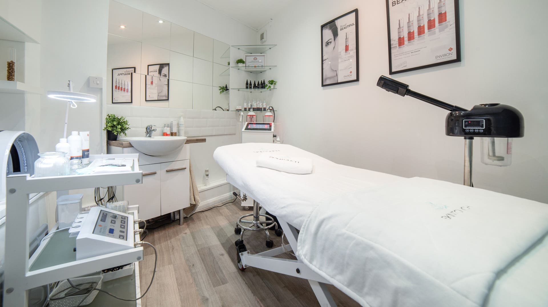 Bright treatment room at Skin Touch, London, England, GB, showcasing modern skincare equipment and decor.