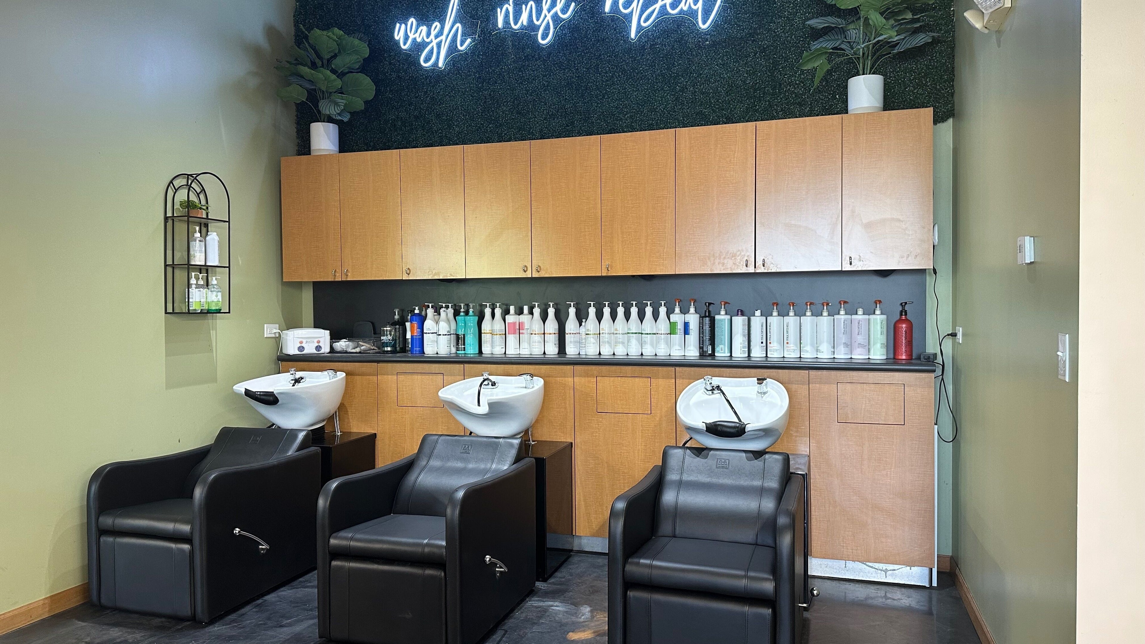 Chic salon wash station at Fantastic Sams, New Lenox, Illinois, US, with modern black chairs and stylish décor.