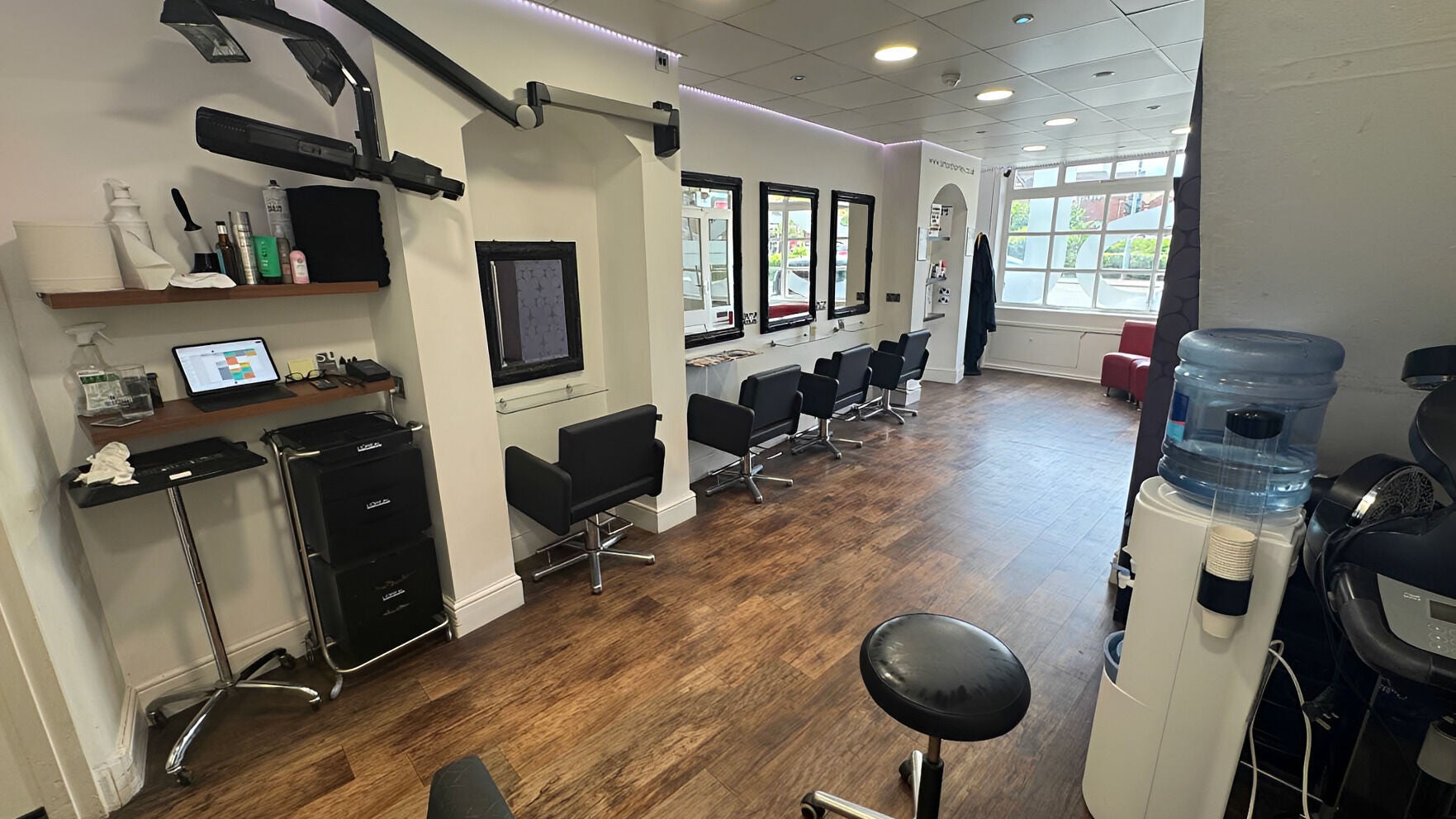 Modern salon interior at Simon Thornley Hair Design, Sutton Coldfield, England, GB, showcasing sleek styling stations.