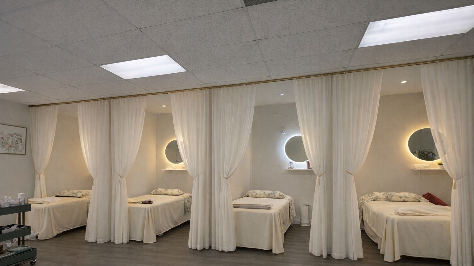 Elegant treatment beds with soft curtains at Magic Lashes Beauty Brea, Brea, California, US. Perfect for relaxation.