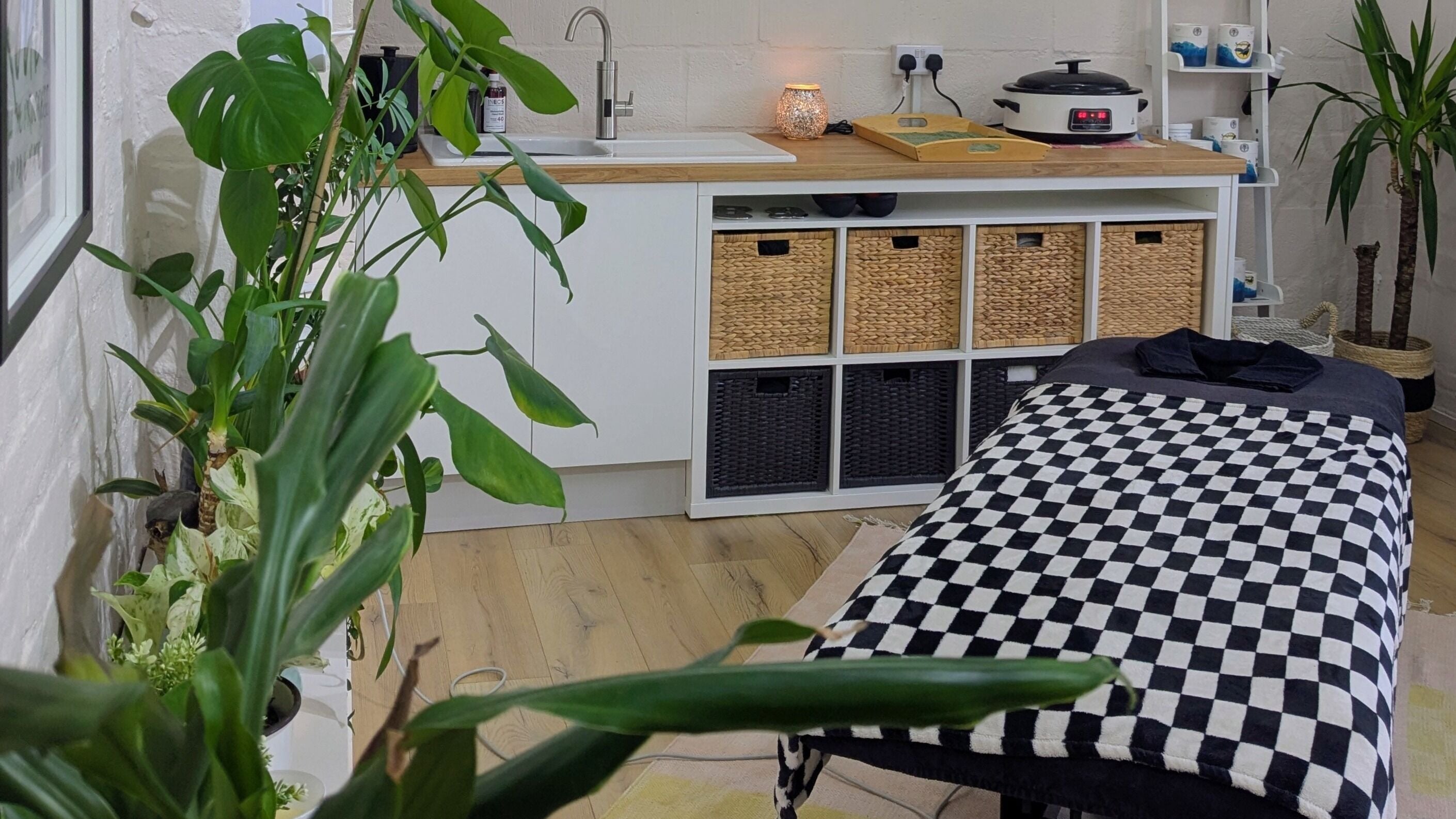 Relaxing therapy room at Claire Colley Sports Rehab and Massage Therapy, Writtle, England, GB with plants and massage table.