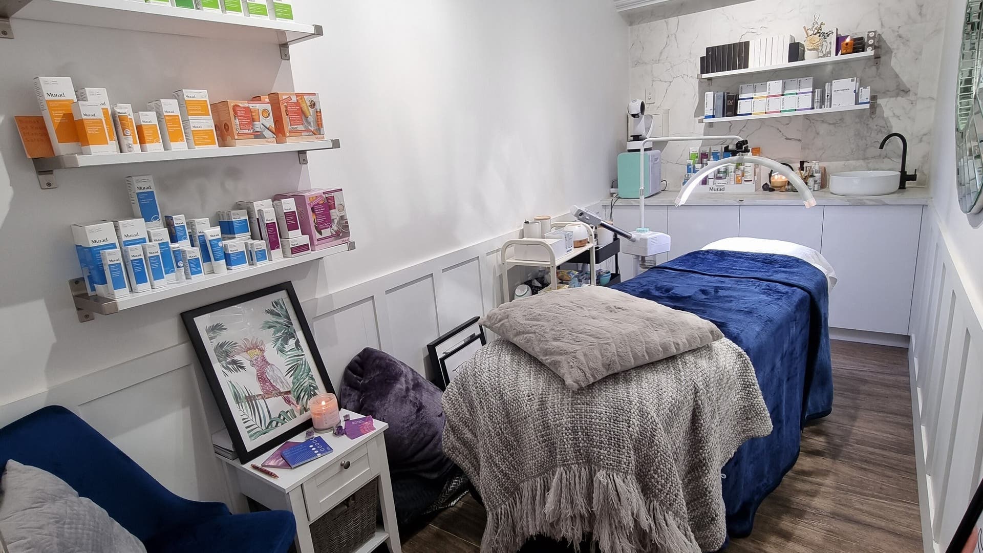 Cozy treatment room at Therapy Beauty, Albion, Queensland, AU, featuring products and comforting decor.