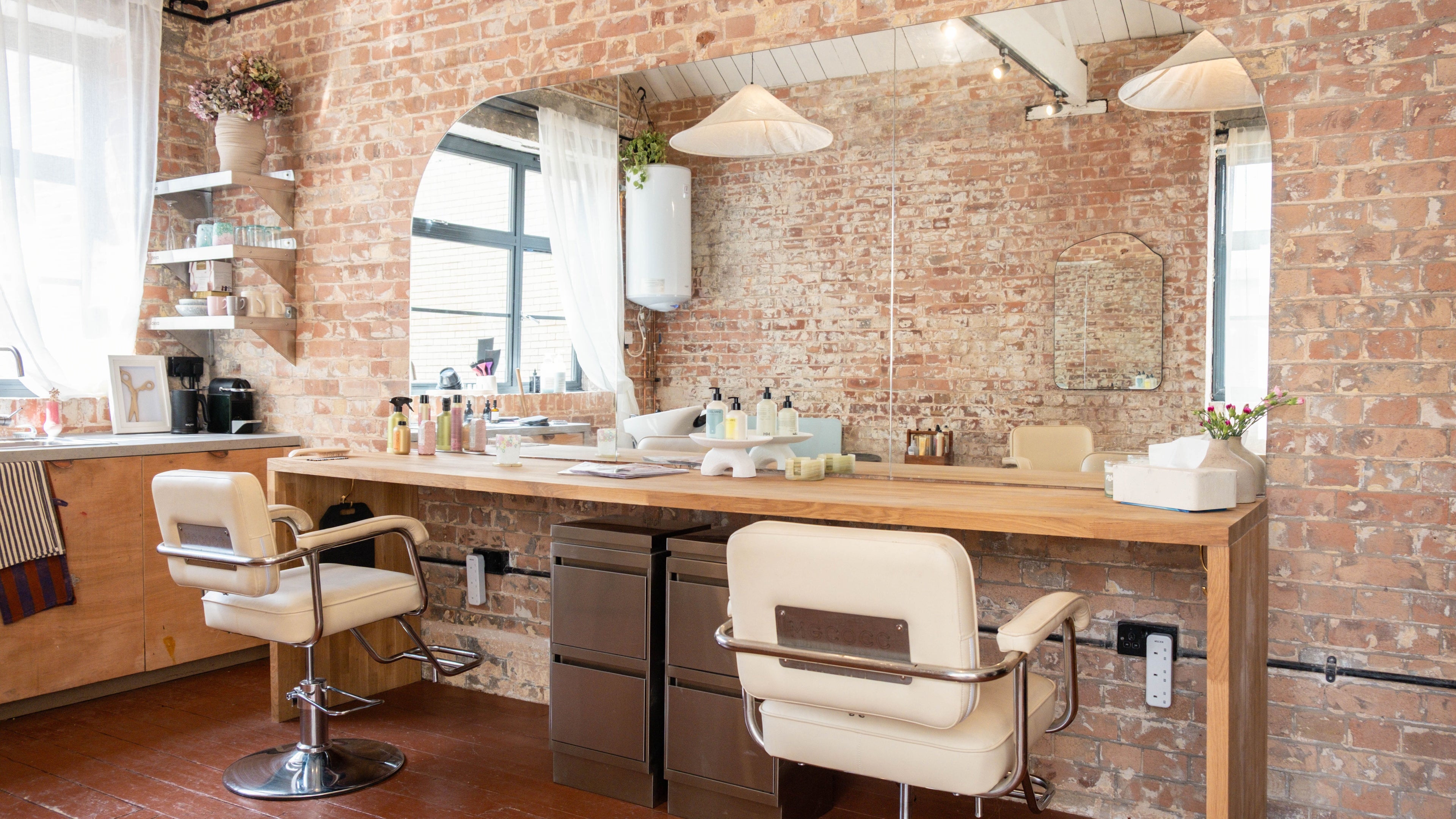 Modern salon interior with brick walls at Fluff.Hackney, London, England, GB.