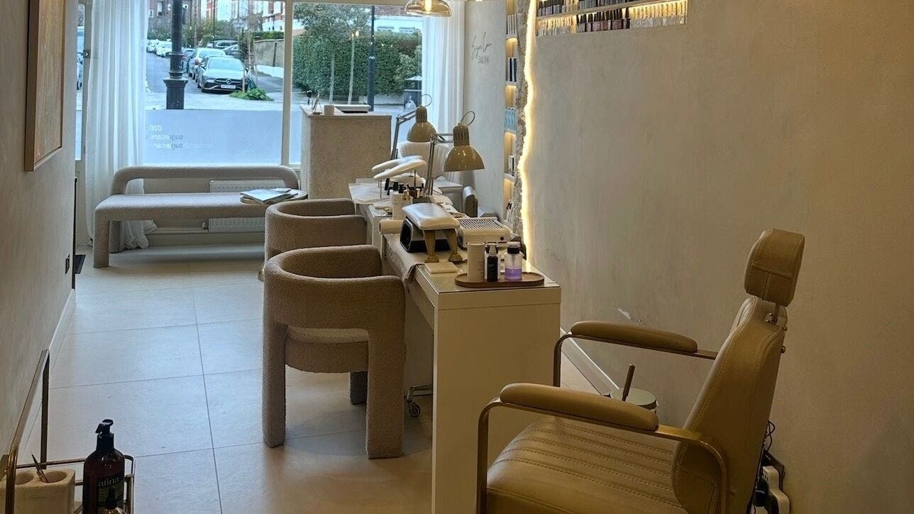 Interior view of Sugar Cane Salon in London, England, GB showcasing cozy seating and modern salon equipment.