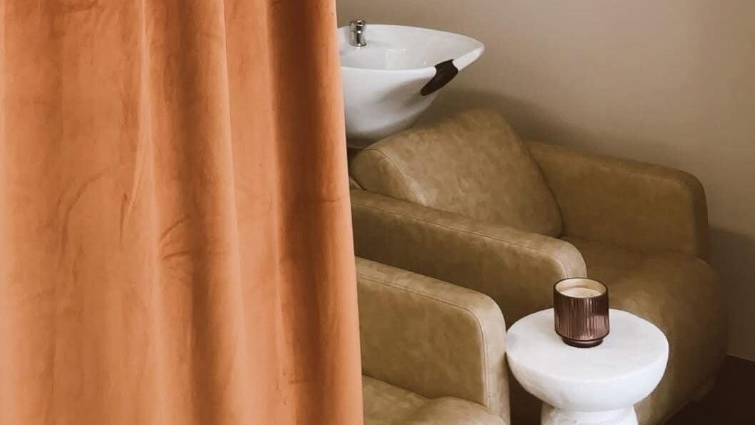 Elegant salon seating at Club Sumé - Suman, Calgary, Alberta, CA, with a stylish wash basin.