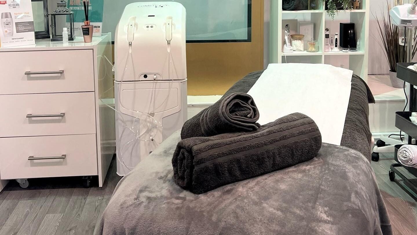 Cozy treatment bed with neatly folded towels at RSB Aesthetics in Blackburn, England, GB.