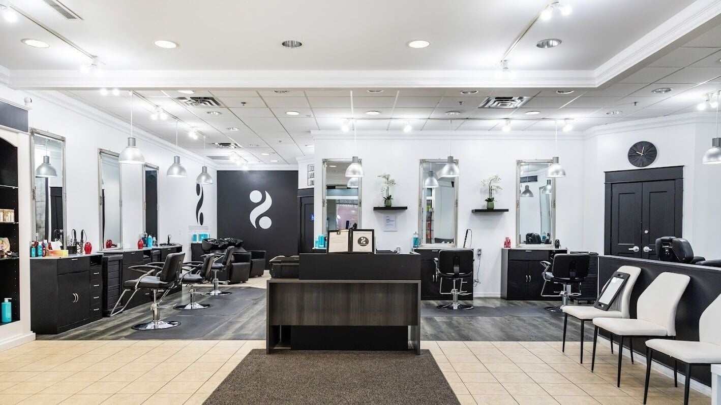 Modern salon interior at 2 Percent Hairstudio in Windsor, Ontario, CA, showcasing sleek styling stations and seating.