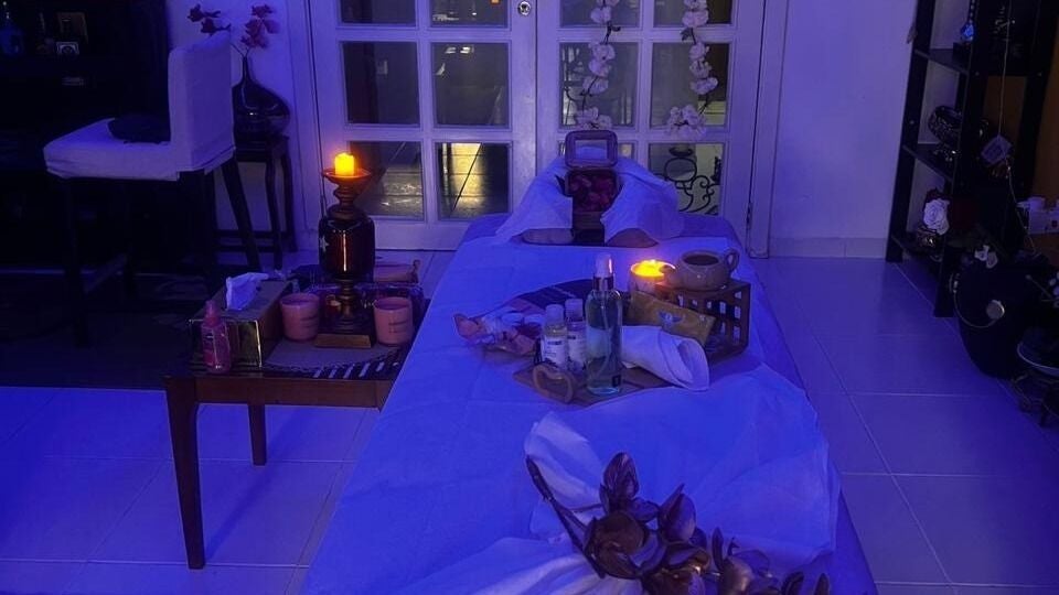Cozy spa setup at Moon Valley Shine Spa - Home Service in Dubai, AE, featuring candles and wellness products.