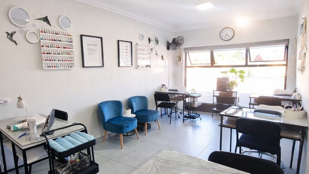 Bright, modern interior of La Bella Salon in Alberton, Gauteng, ZA, featuring chic seating and decor.