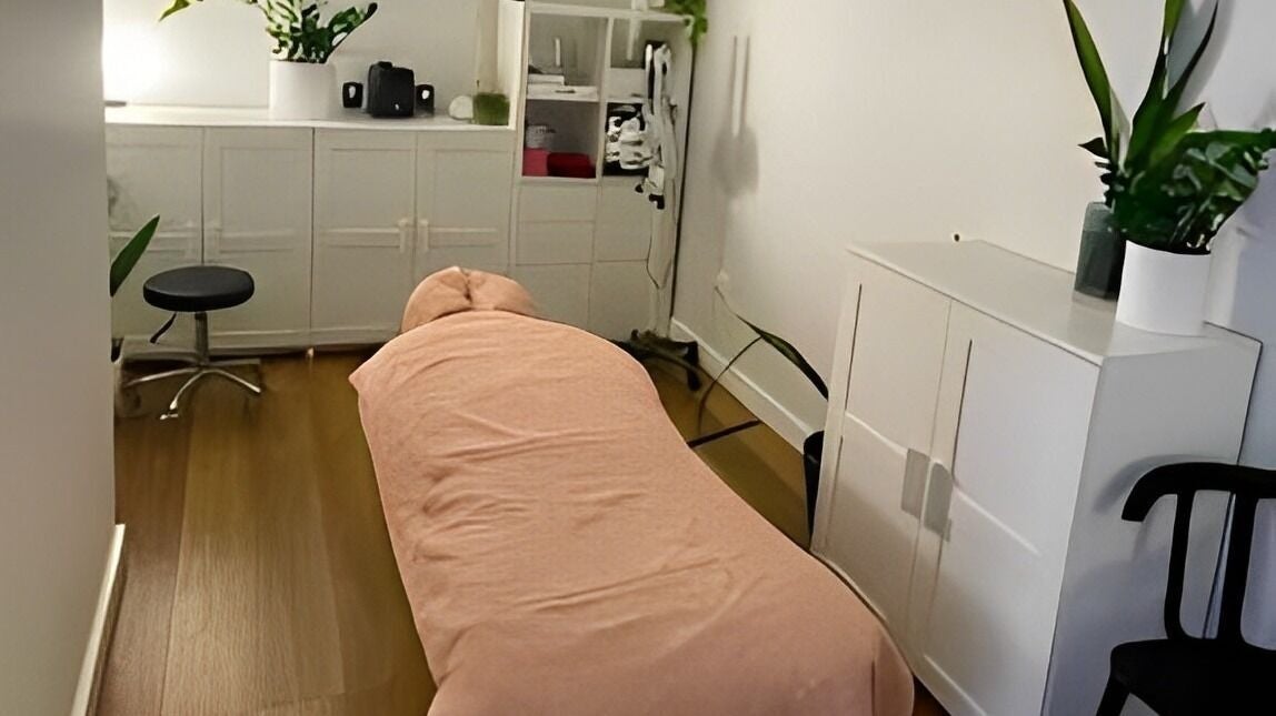 Tranquil treatment room at Pali Healing Arts, Petersham, New South Wales, AU, featuring massage table and plants.