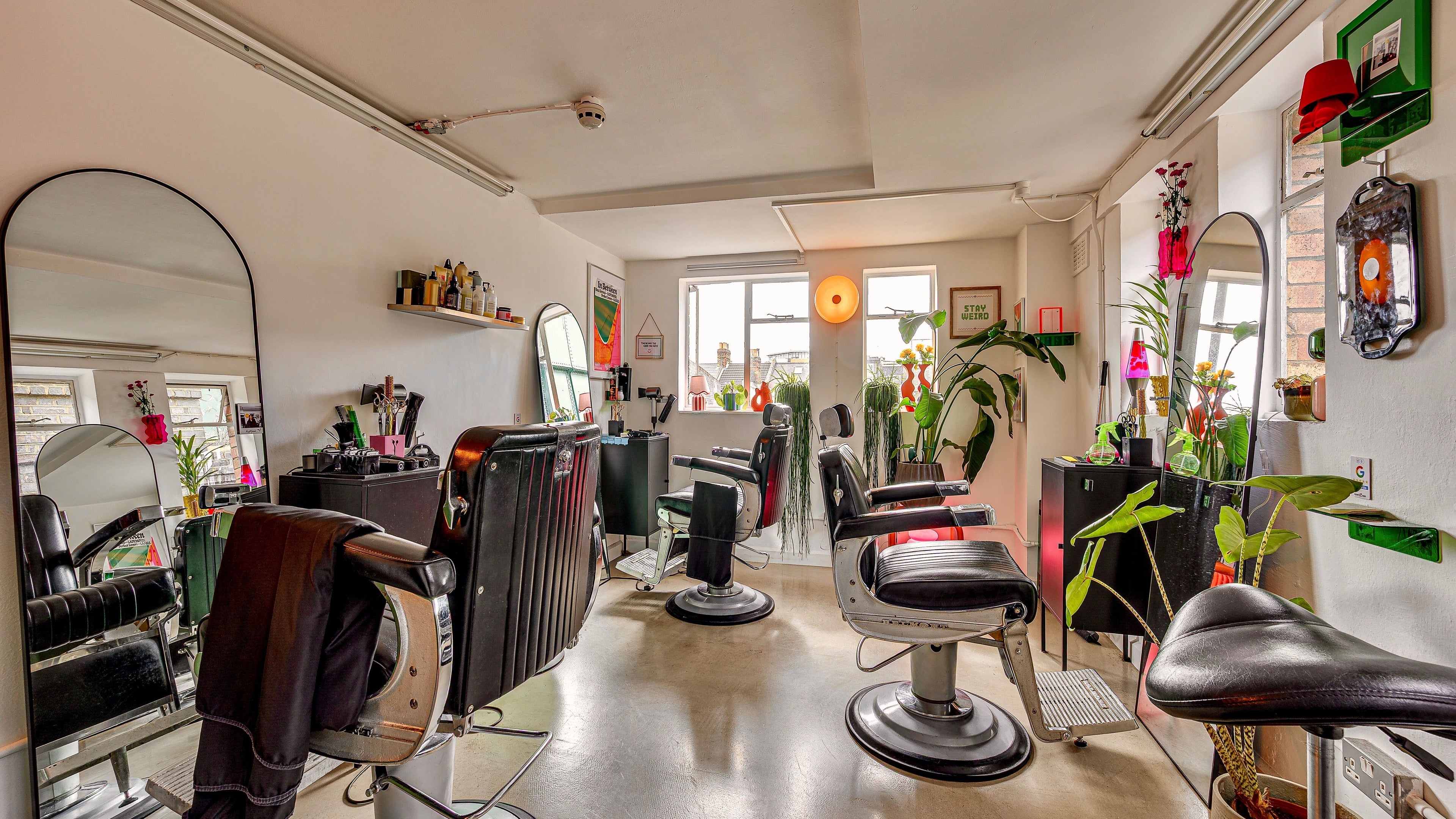 Bright and stylish interior of Lume Hair Studio | Netil Lane, London, England, GB, featuring modern salon chairs and mirrors.