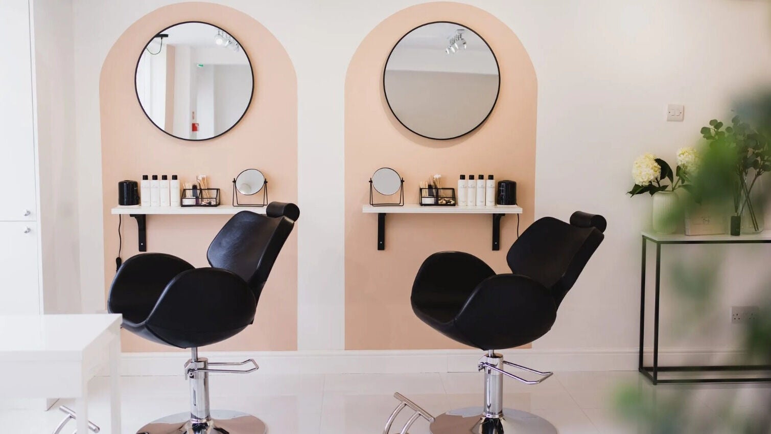 Elegant salon interior at Allure Beauty, Quorn, England, GB showcasing stylish chairs and mirrors.