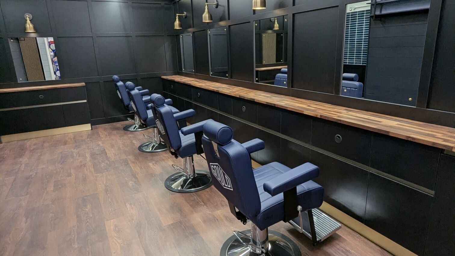 Gould Barbers Lowestoft's modern interior in Lowestoft, England, GB with stylish chairs and mirrors.