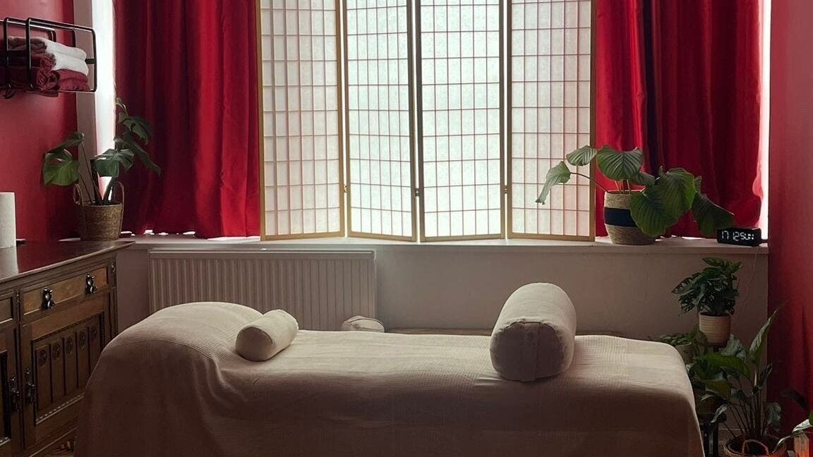 Relaxing massage room at The Talking Body Clinic, Glasgow, Scotland, GB with plush bed and ambient lighting.
