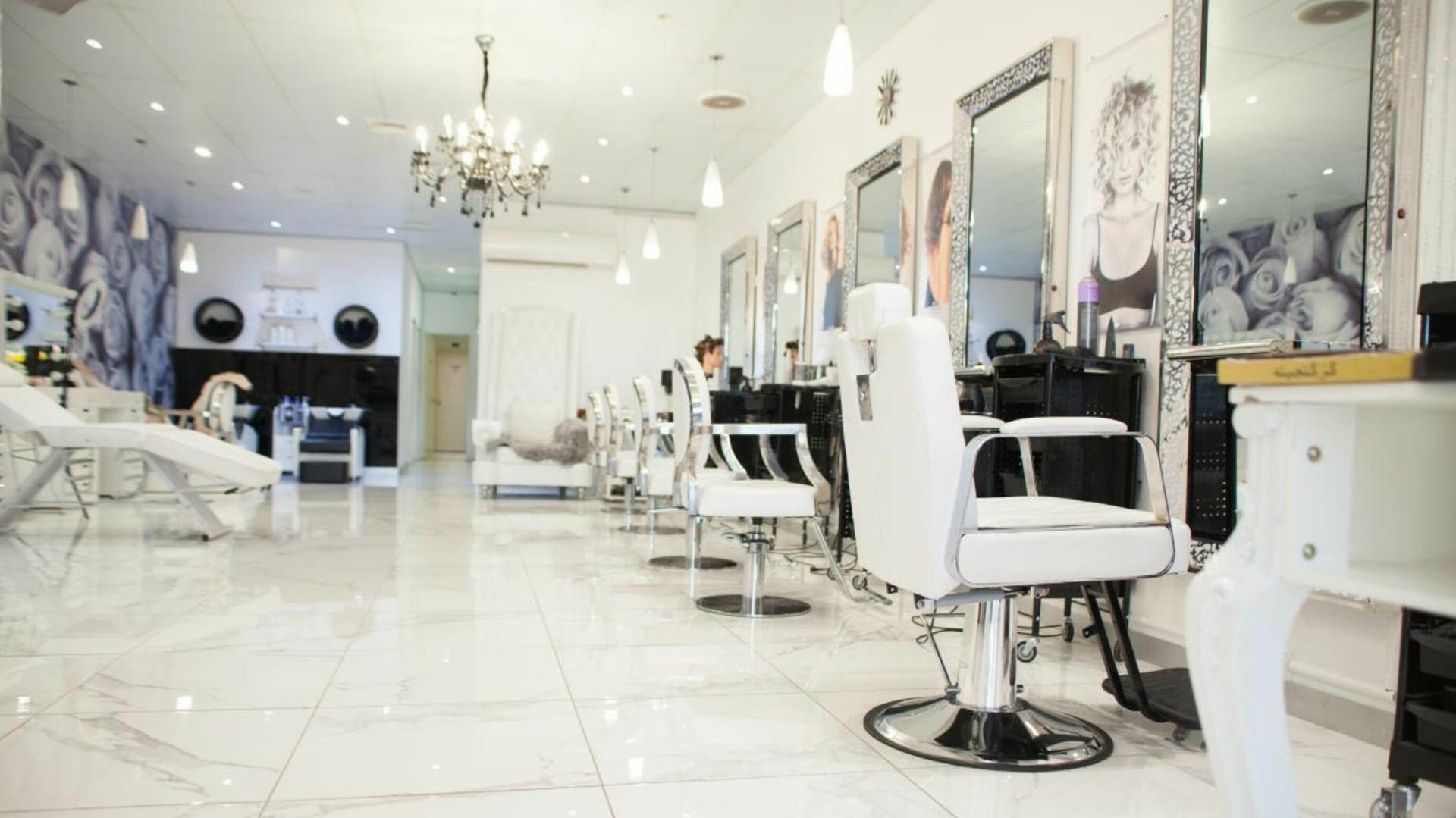 Alia Hair and Beauty salon in Melbourne, Victoria, AU features chic white decor and modern styling chairs.