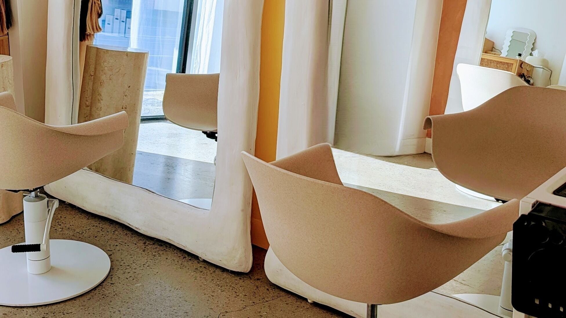 Stylish salon chairs and mirrors at Lia Hanson Hair, Melbourne, Victoria, AU, showcasing a modern beauty space.