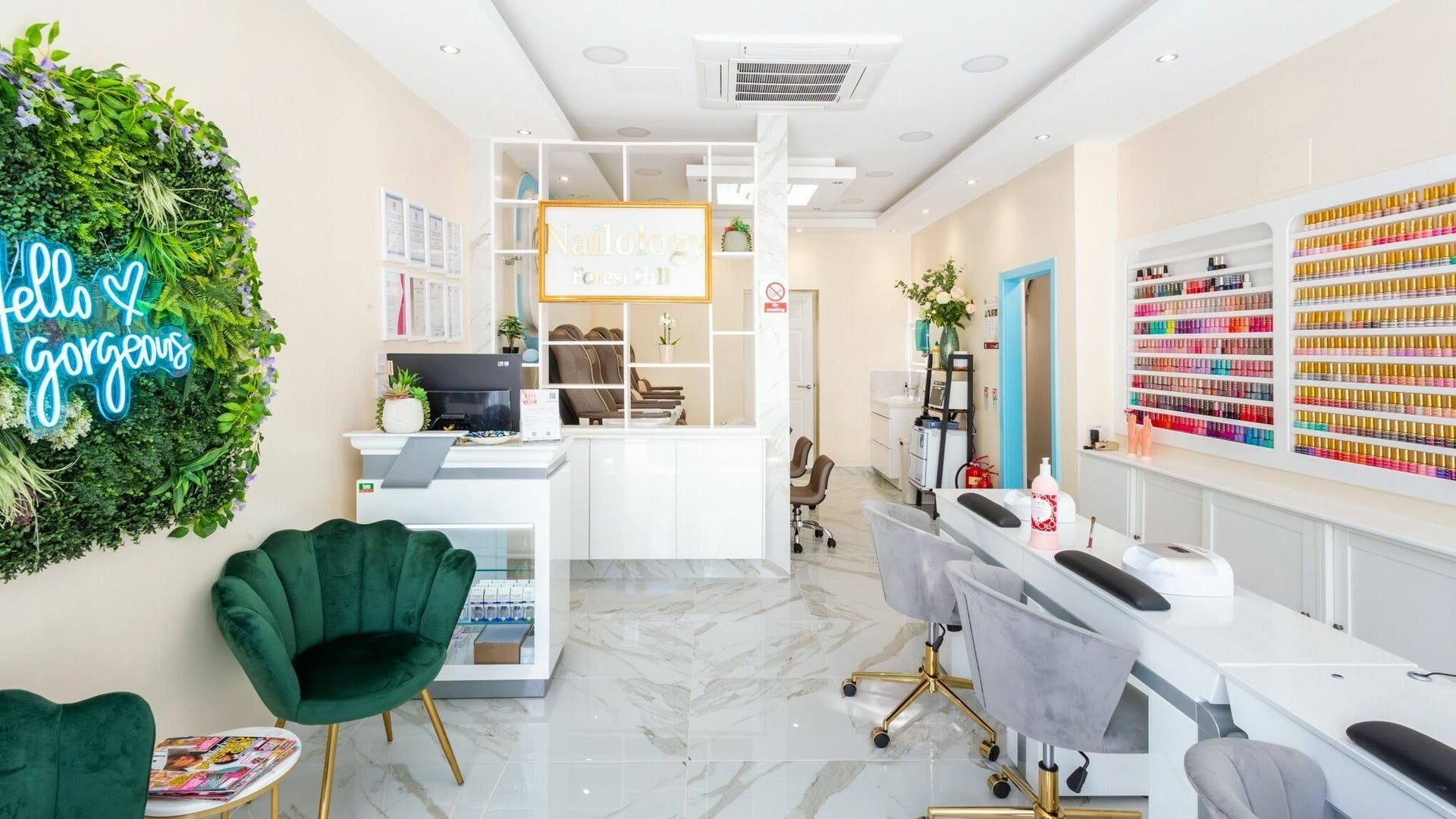 Elegant interior of Pamper Nail Bar in London, England, GB. Modern, bright space with nail polish display and seating.