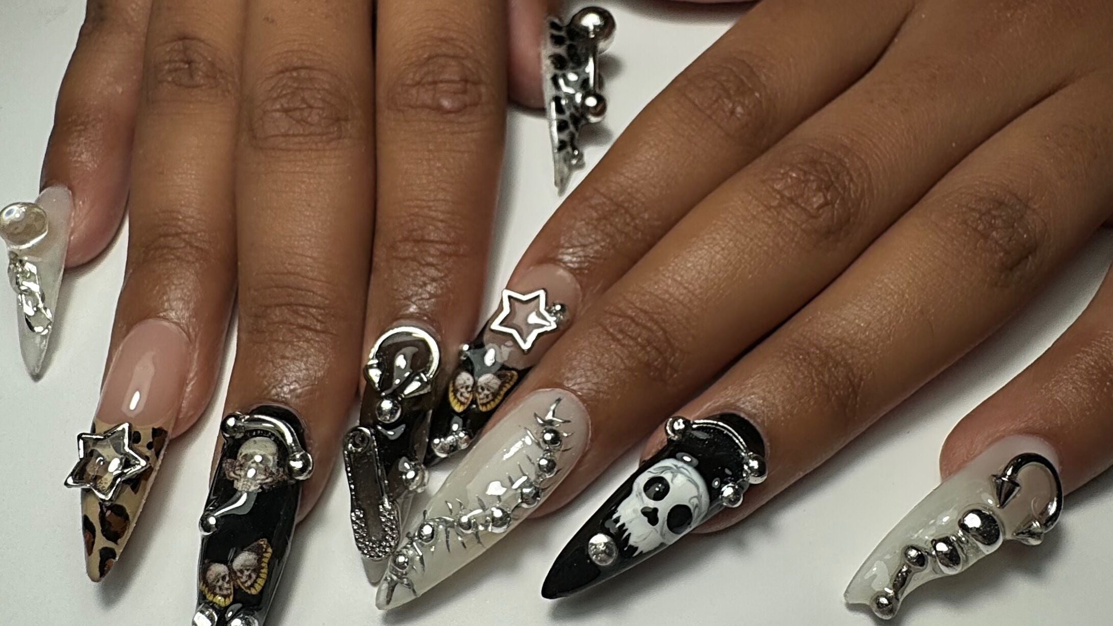 Intricate nail art at Gellraiser, Brighton And Hove, England, GB, featuring silver and black decorative designs.
