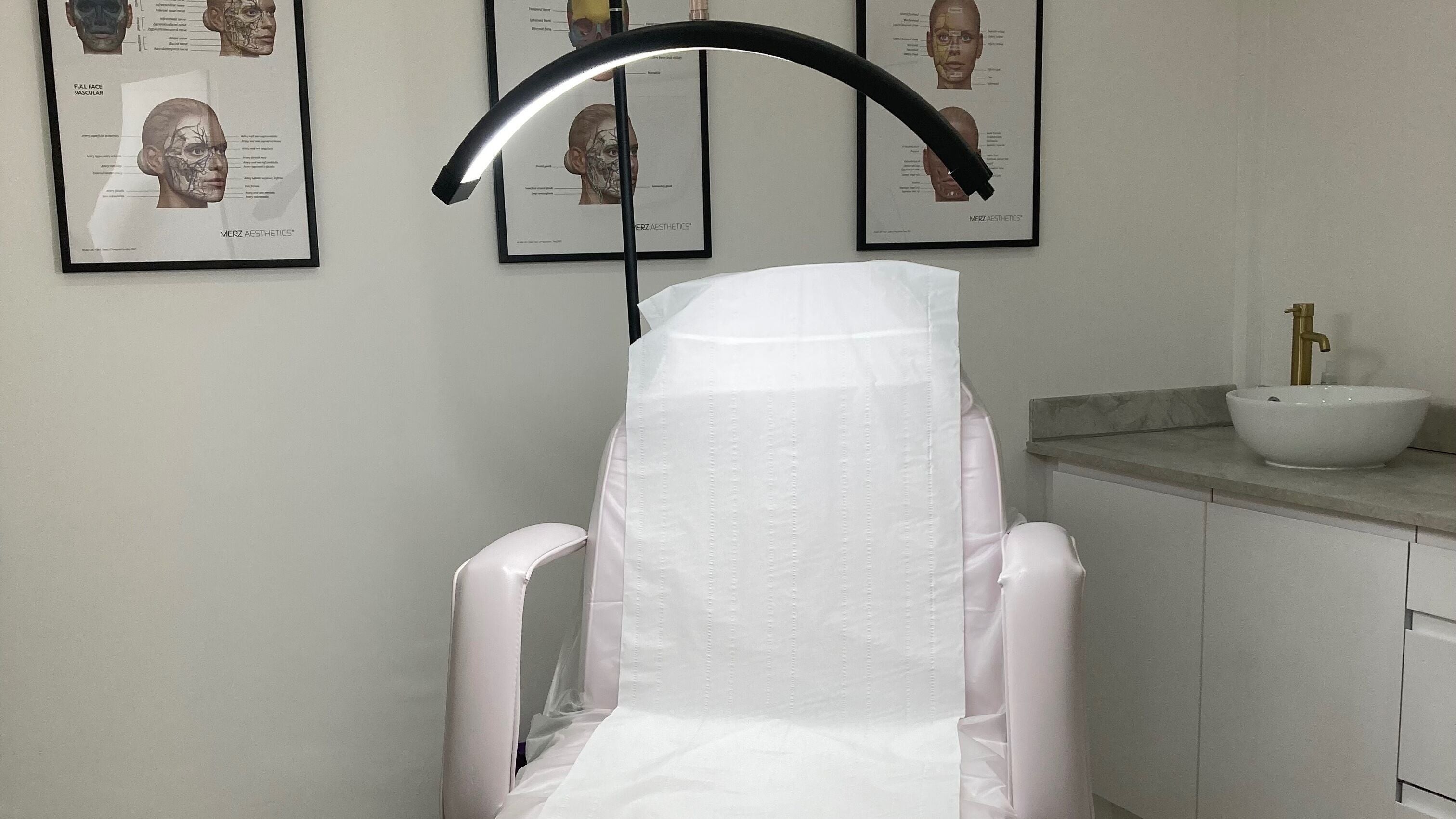 Modern treatment chair at Lucy Angel, Lowestoft, GB, under a halo light, exuding a sense of professional care.