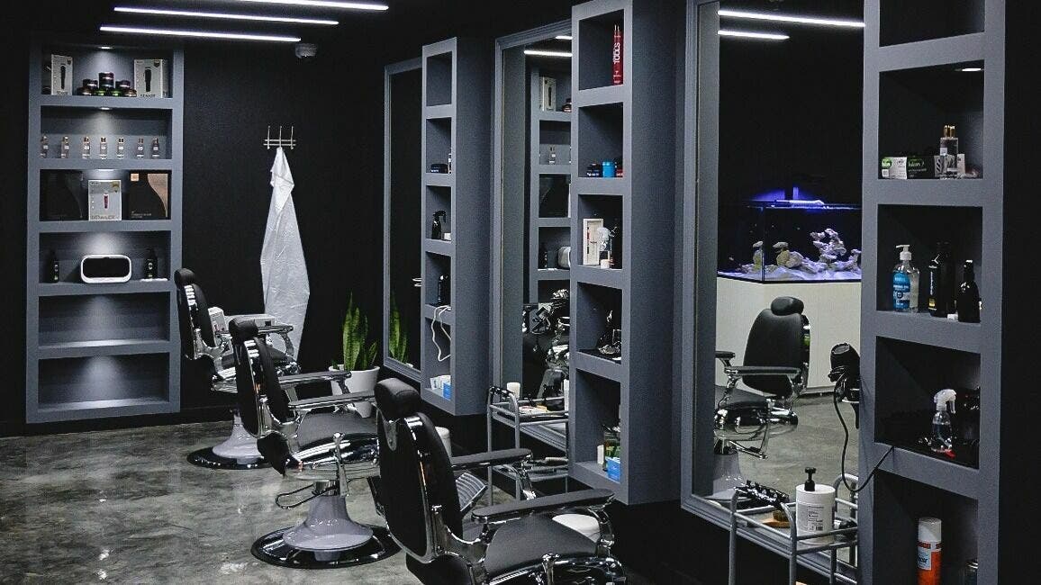 Elegant interior of Perfect Home Gents Center in Sharjah, AE showcasing modern barber chairs and shelves.