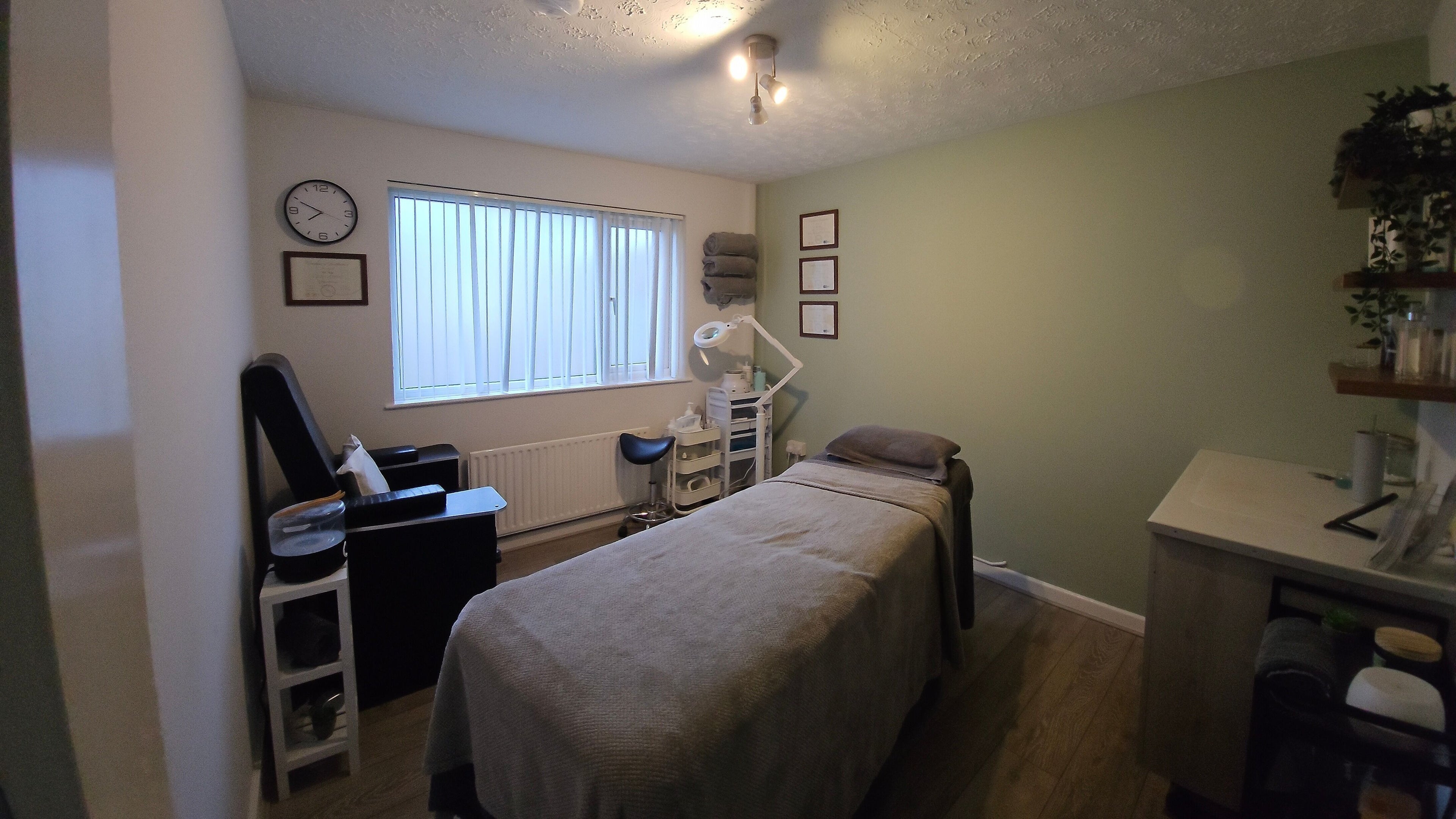 Calm treatment room at The Nail Gallery and Beauty, Bodmin, England, GB with a comfy bed and soothing decor.