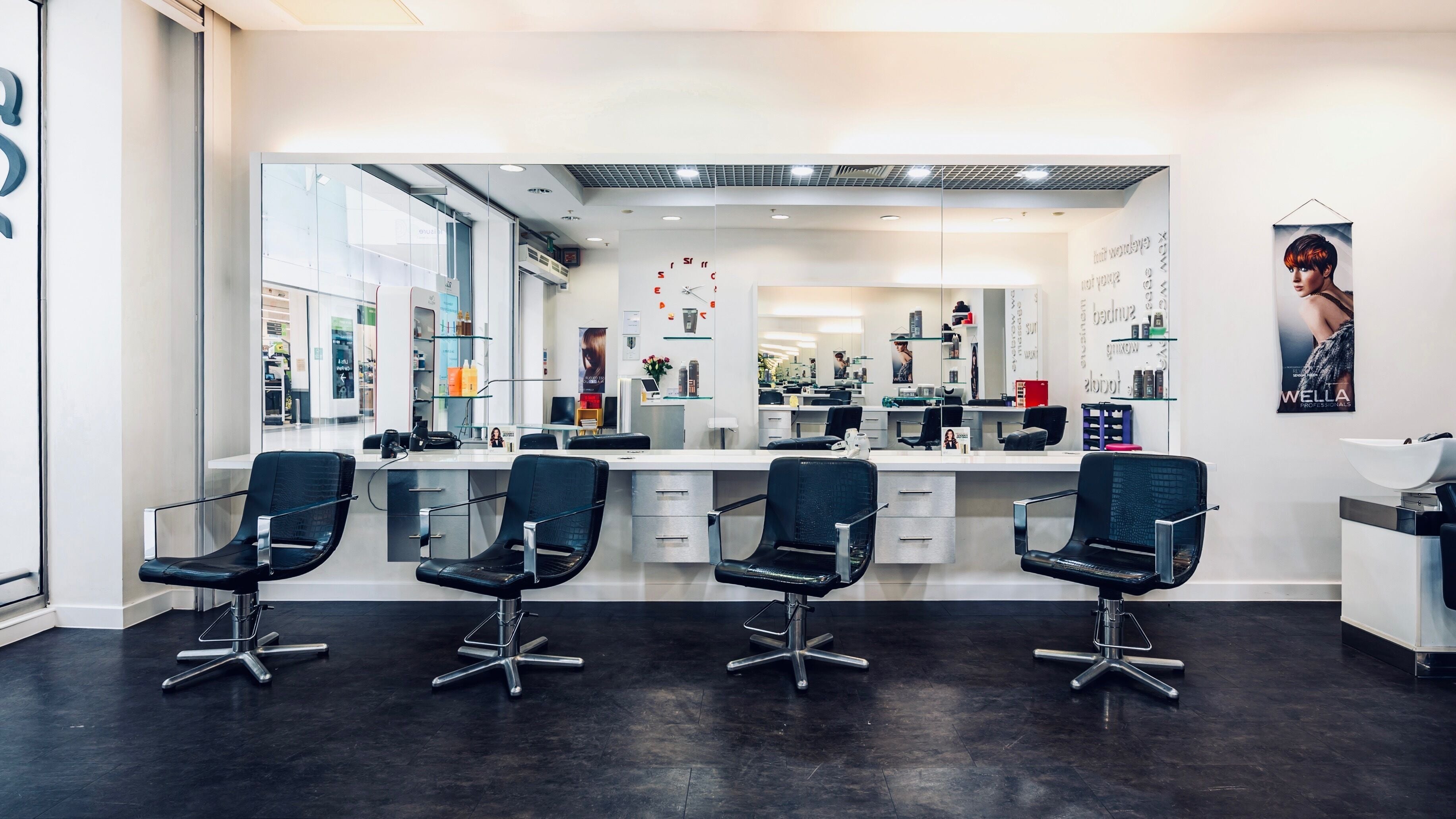 Modern salon chairs at Vida Hair & Beauty The Mercury in Romford, England, GB with sleek mirrors and decor.