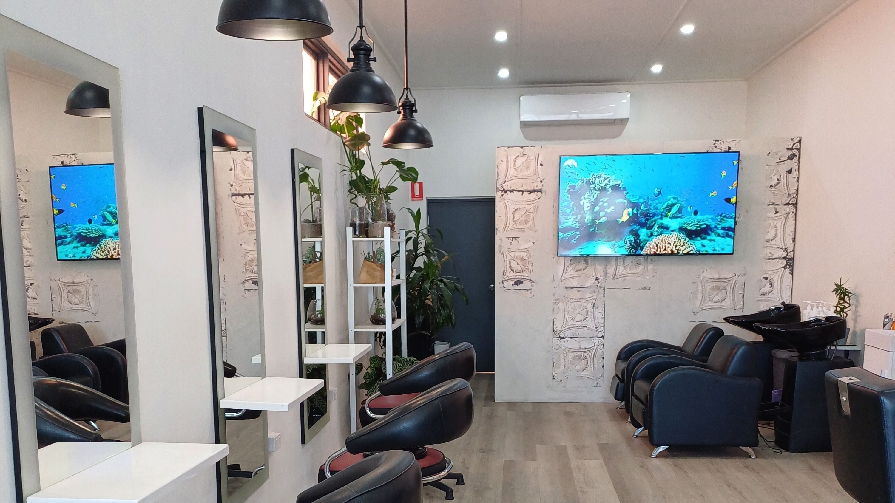 Modern interior of Unseen Hair Salon in Melbourne, Victoria, AU, featuring sleek chairs and luxury decor.