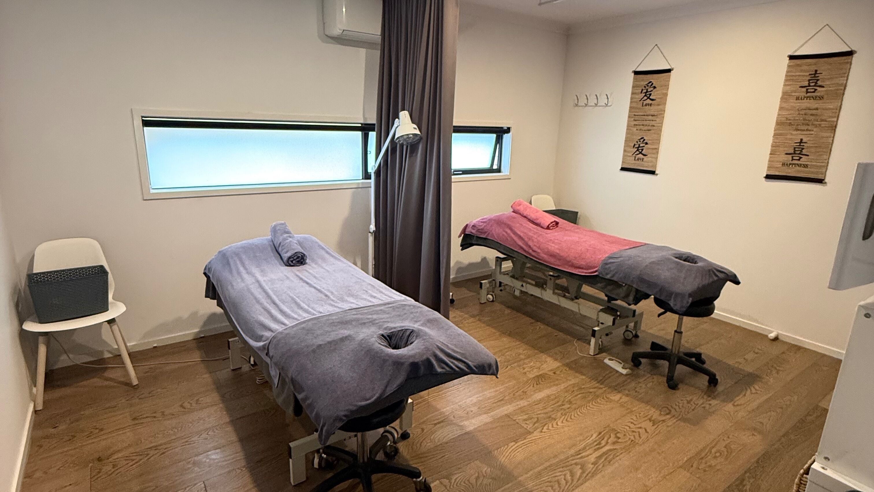 Therapy room at Yuan Muscle Therapy in Melbourne, Victoria, AU with two massage tables and calming decor.
