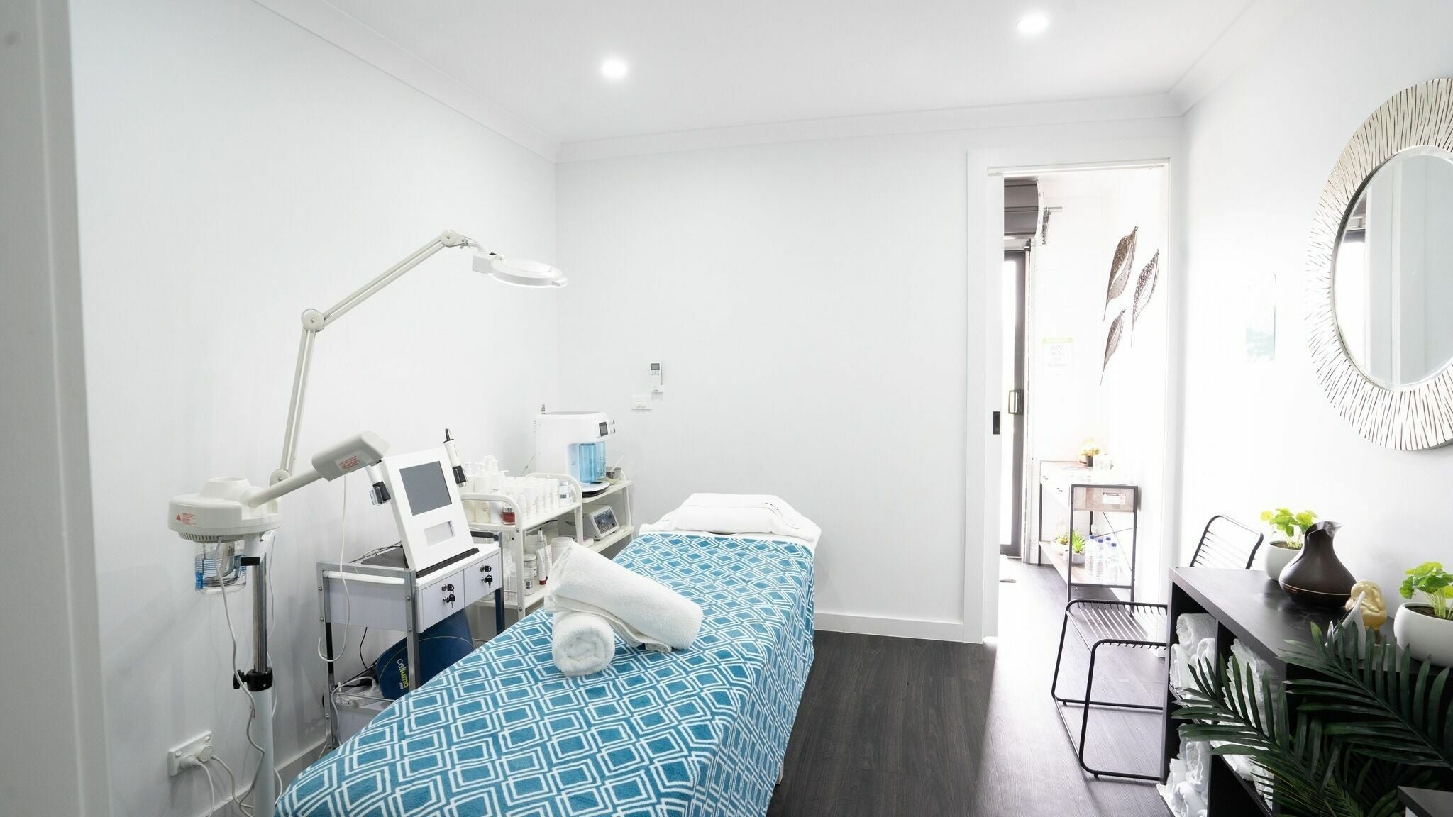 Calm treatment room at I Glow Skin Spa, Burnside, Victoria, AU, featuring a massage table and modern equipment.