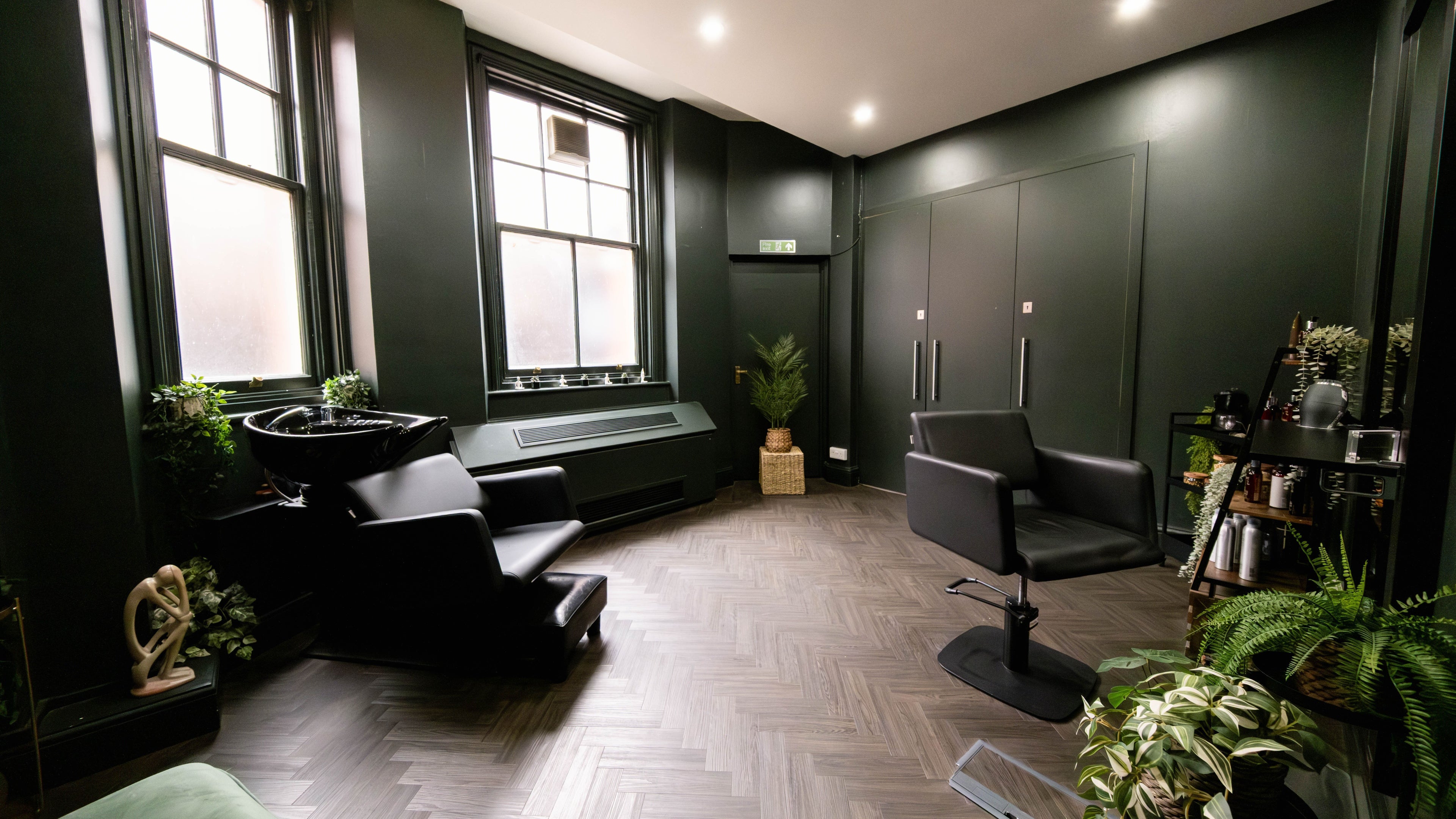 Elegant interior of Jivan Room in London, England, GB featuring modern chairs and lush plants.