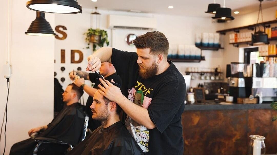 Stylist at His Lid in Subiaco, Western Australia, AU, perfecting a haircut in a modern, welcoming setting.