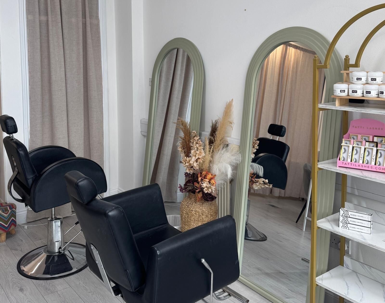 Stylish salon interior at Liv Beauty, Kilmallock, County Limerick, IE with elegant mirrors and floral decor.