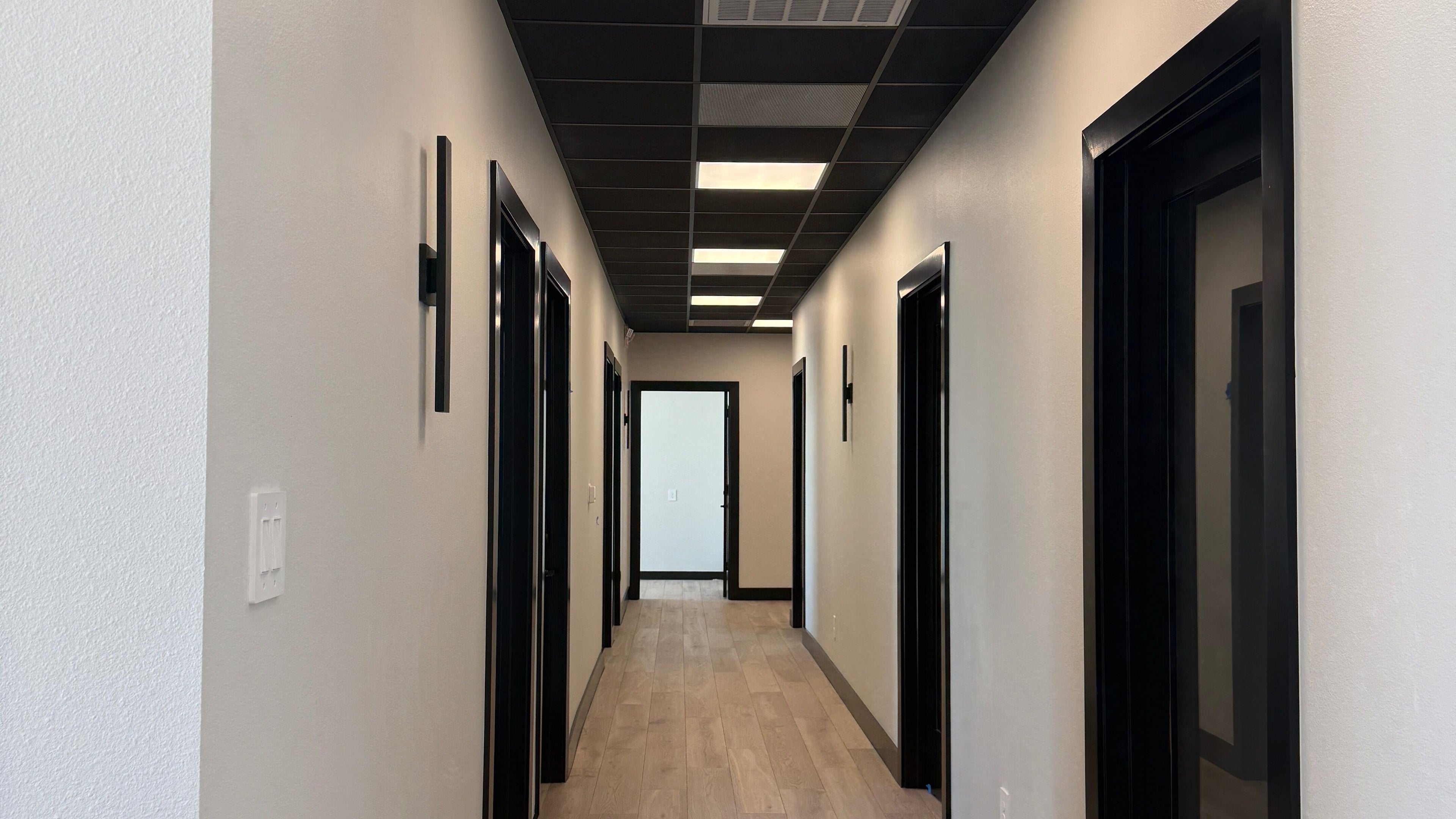 Interior hallway of Cypress Lash Studio, Texas, Texas, US with elegant lighting and modern design.